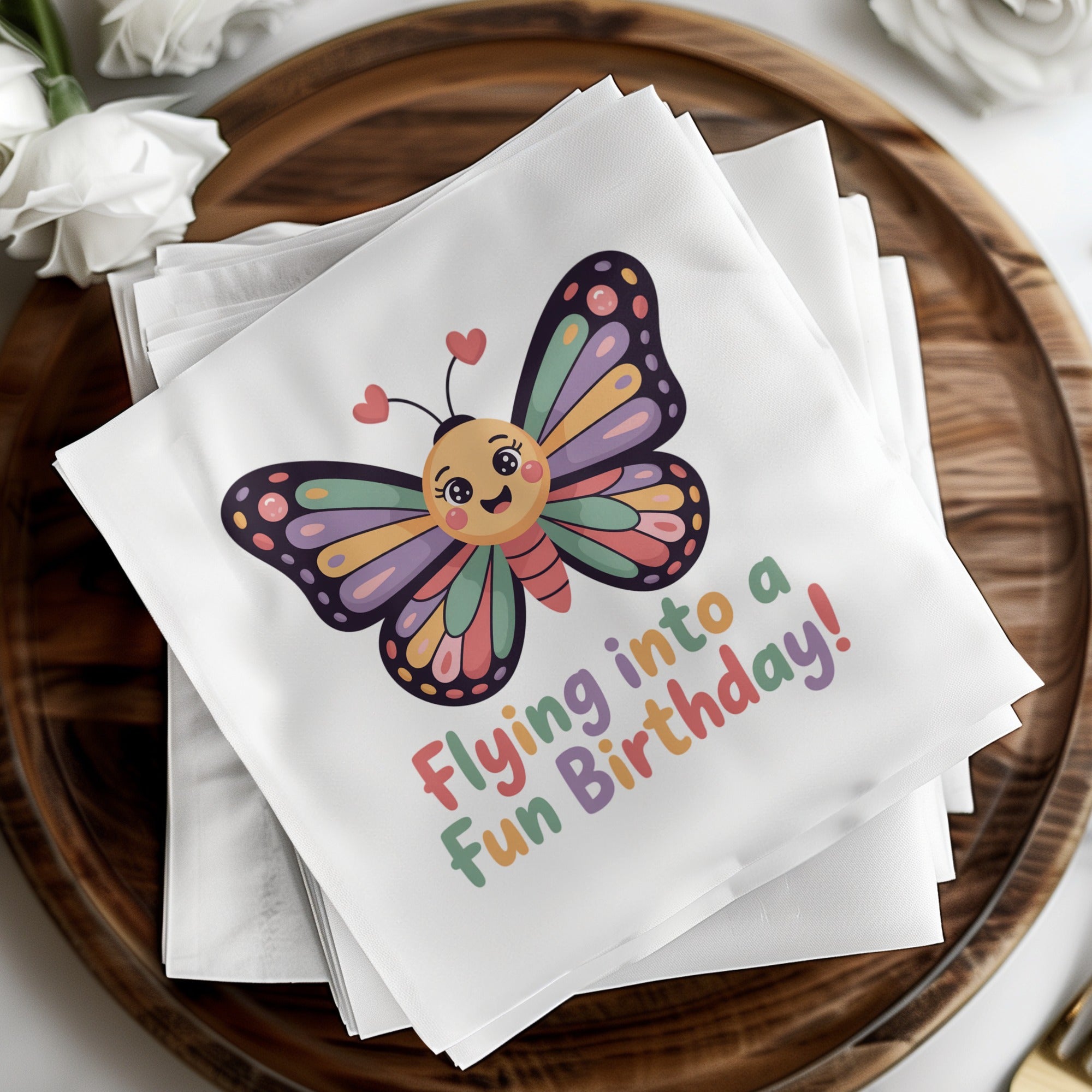White napkins with a colorful cartoon butterfly and "Flying into a fun Birthday!"