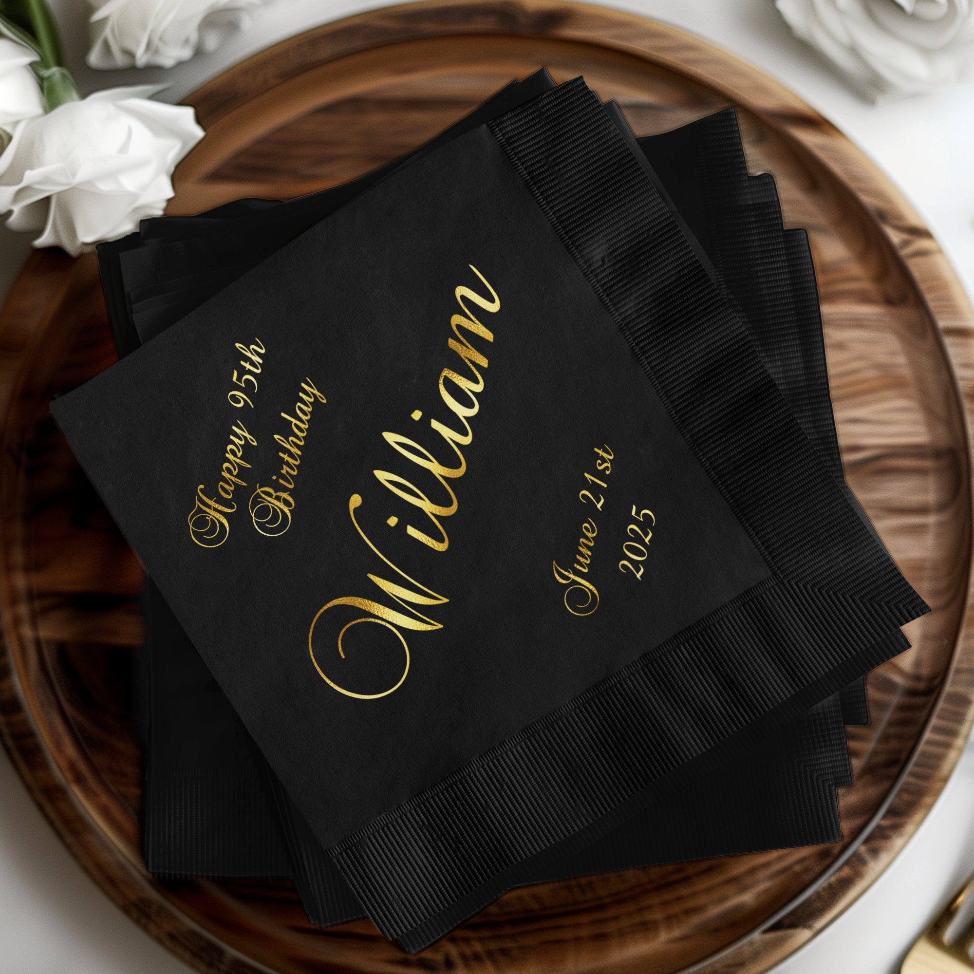 Black cocktail napkins with "Happy 95th Birthday William June 21st 2025" in gold script.