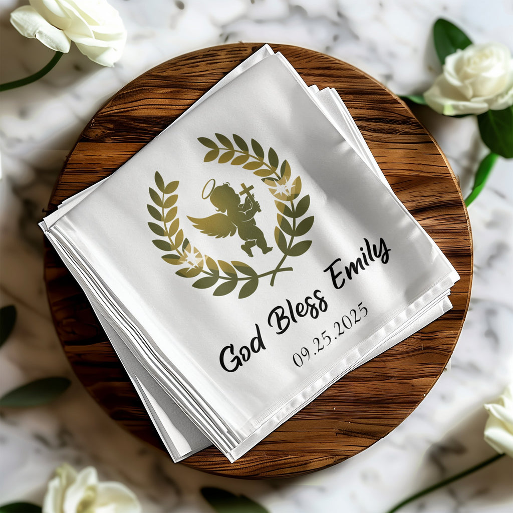 White napkin with "God Bless Emily" and date, featuring an angel and laurel wreath.
