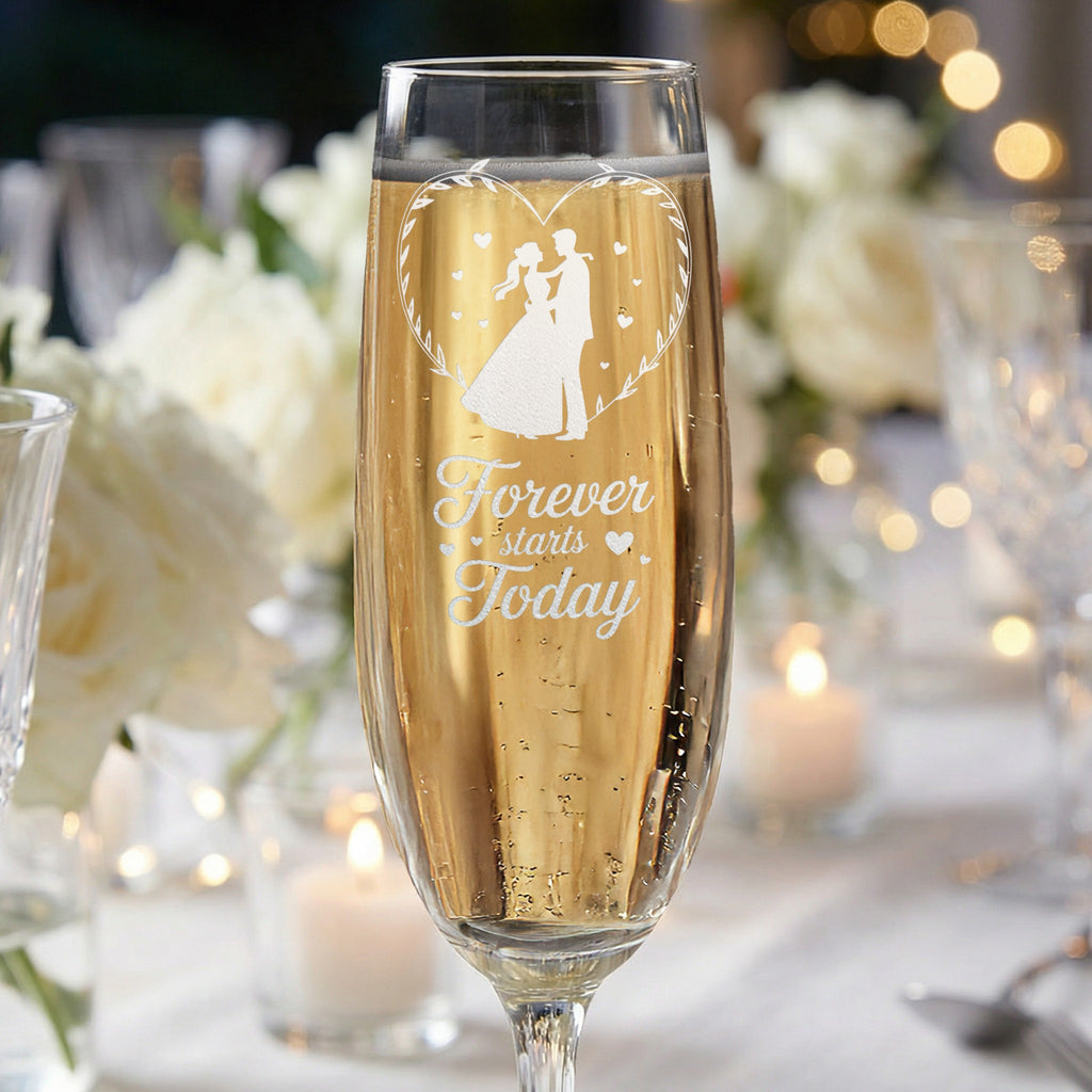 Champagne flute with etched heart silhouette of a couple and text "Forever starts today."