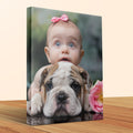 Baby peeking over a bulldog's head with a pink bow.