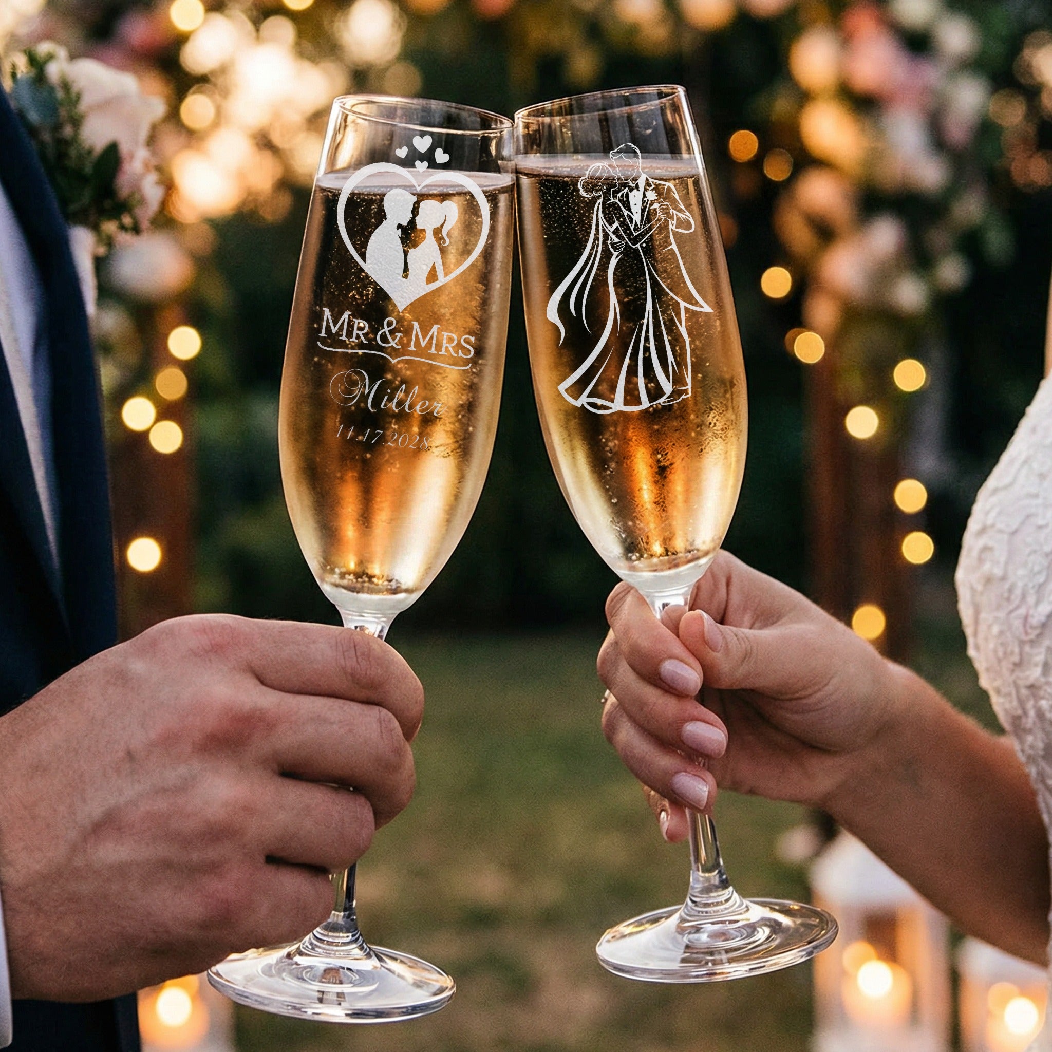 Wedding champagne flutes engraved with couple's names and date, raised in a toast.
