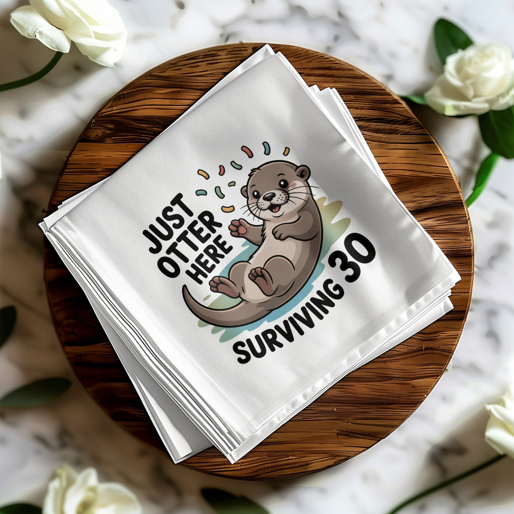 White napkin with "JUST OTTER HERE SURVIVING 30" text and cartoon otter.