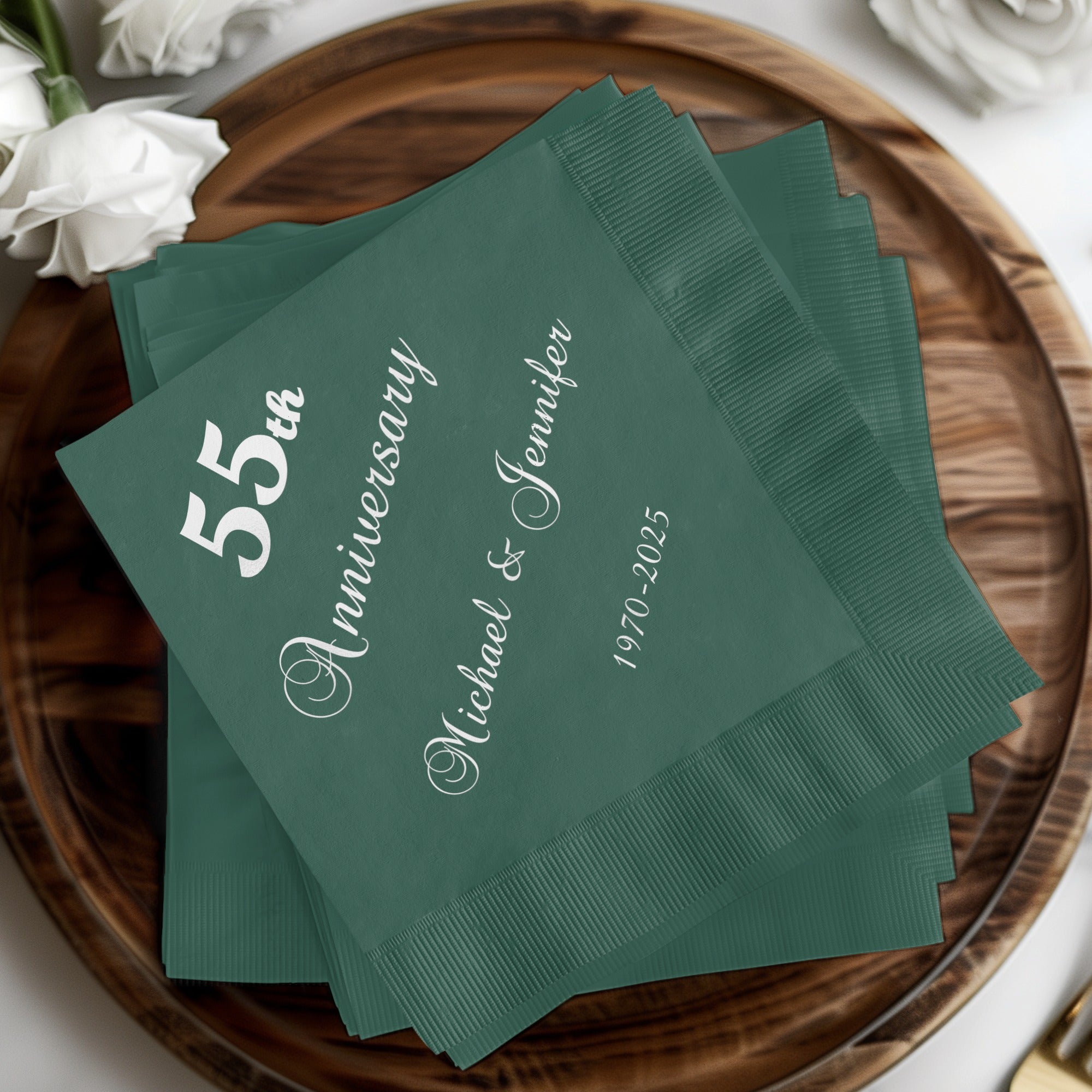 Green cocktail napkins with "55th Anniversary Michael & Jennifer 1970-2025" text.