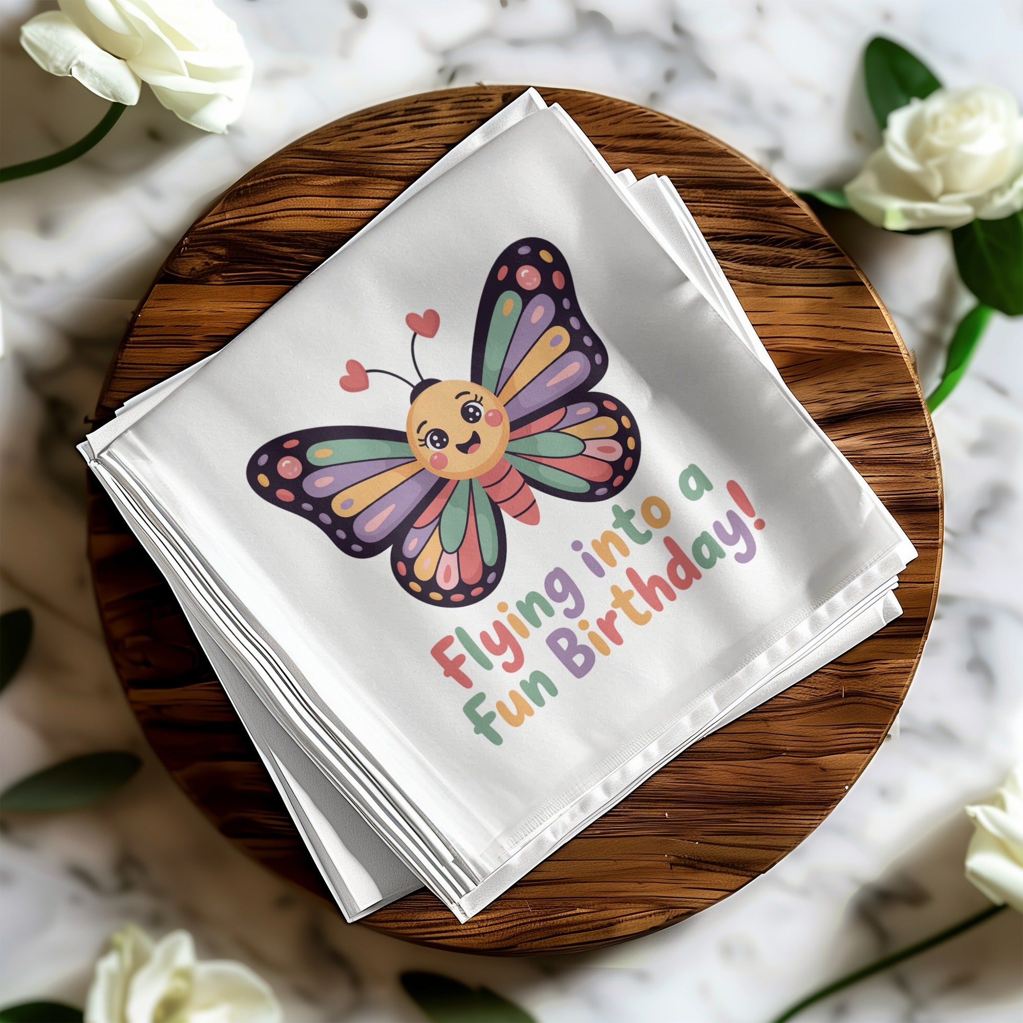 Folded napkin with smiling butterfly and "Flying into a fun Birthday!" text.