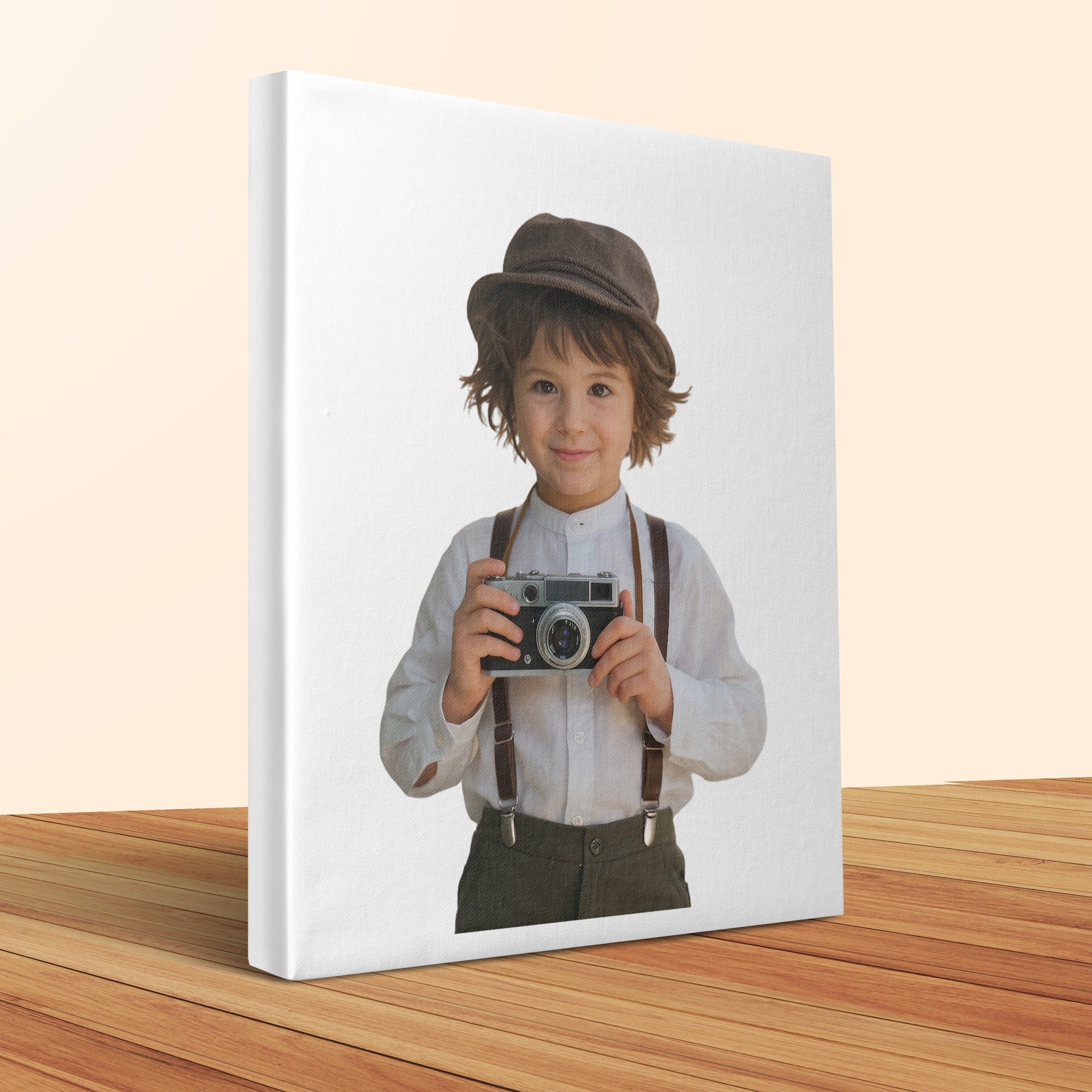 Young boy in hat and suspenders holding vintage camera on canvas.