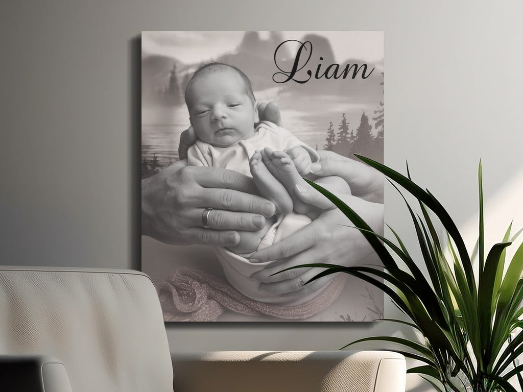 Black and white canvas print of a baby held by parents' hands, with "Liam" in script.