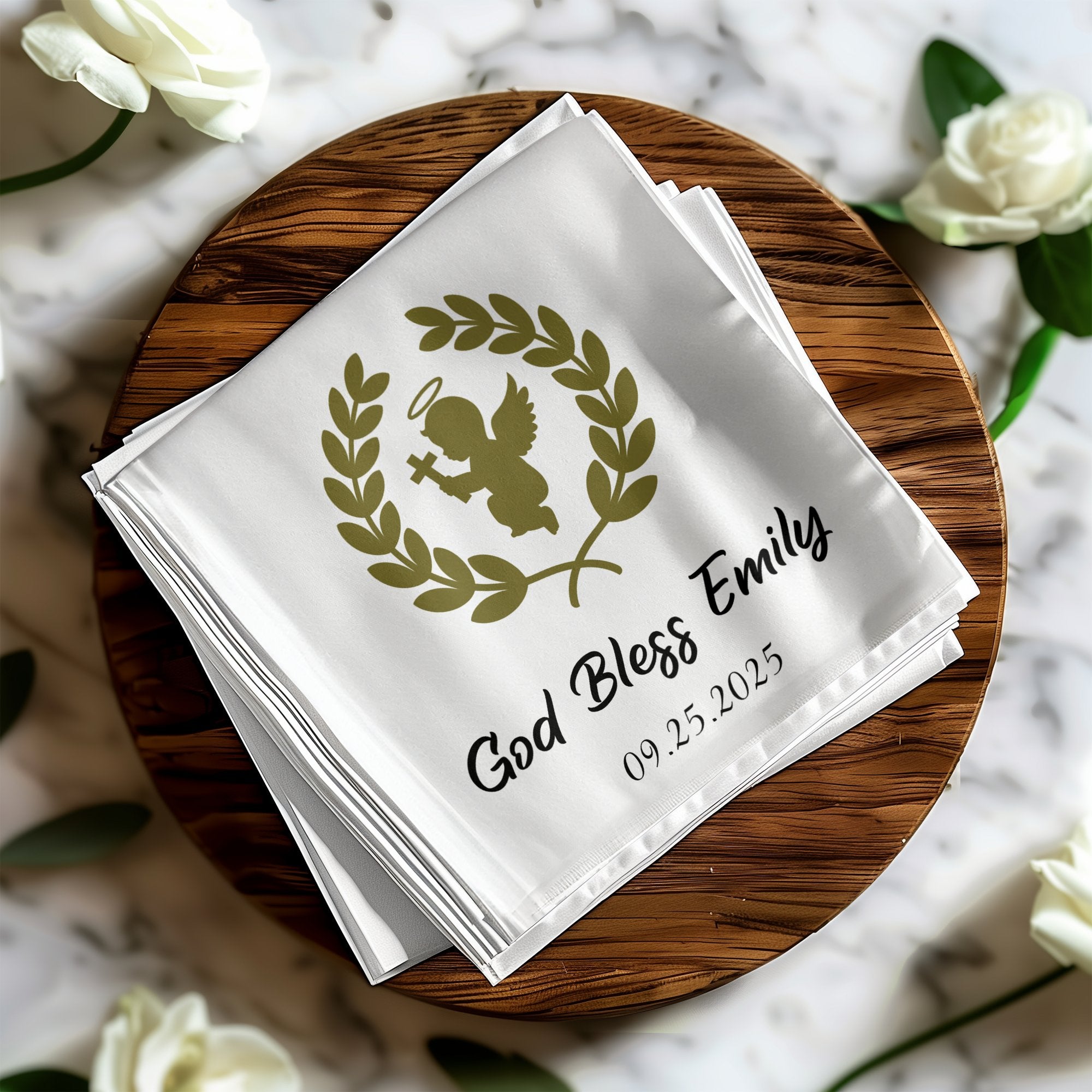 White cloth napkins with gold angel and laurel wreath design, "God Bless Emily 09.25.2025".