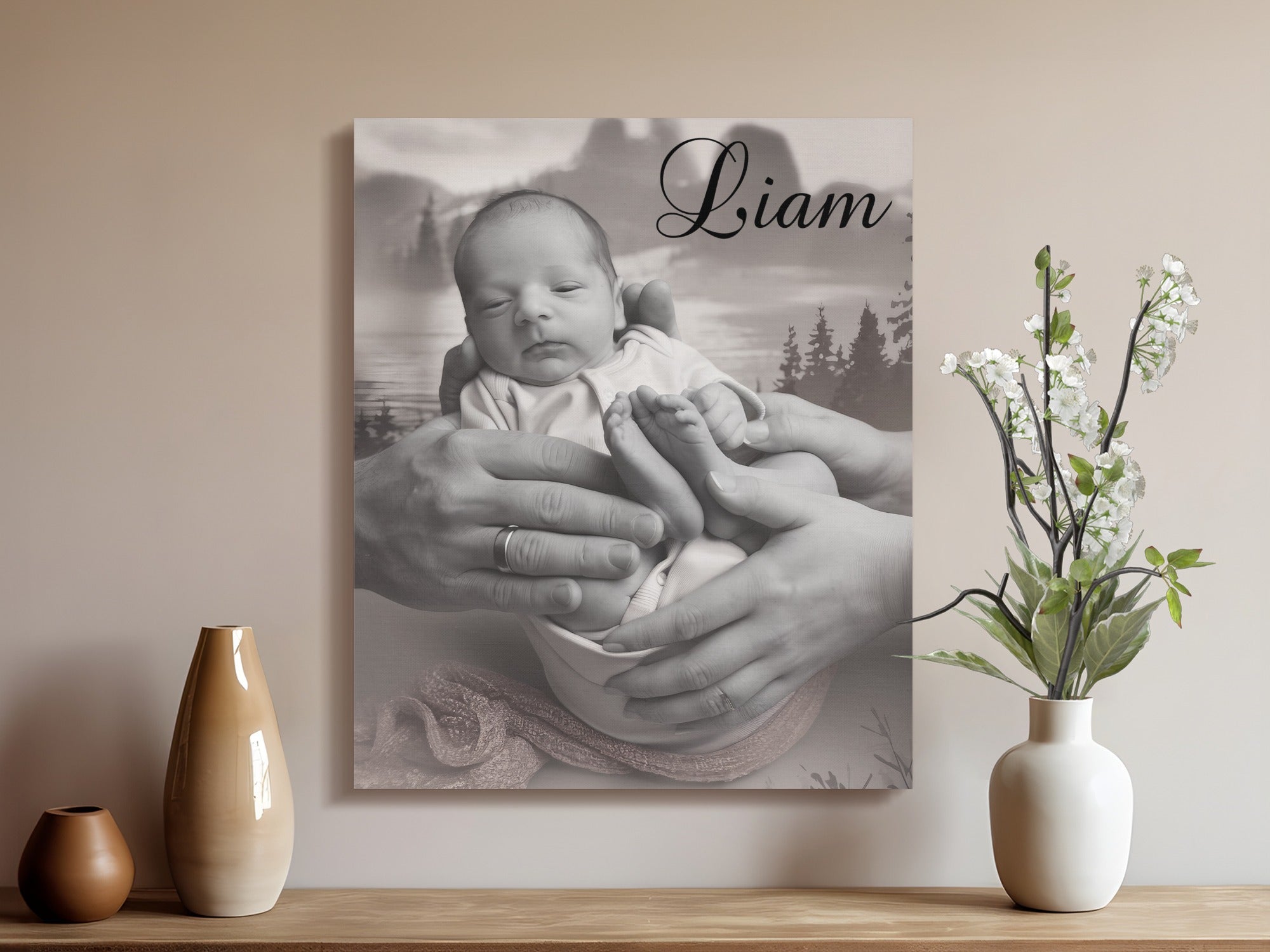 Black and white portrait of a newborn baby held in parents' hands.