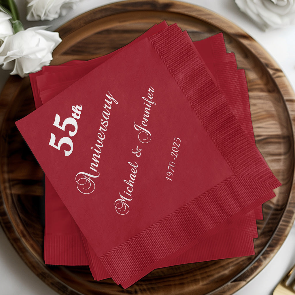 Red cocktail napkins with "55th Anniversary Michael & Jennifer 1970-2025" text.