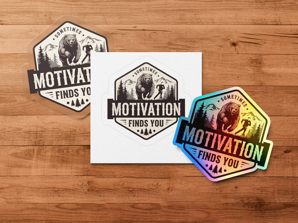 Bear climbing mountain with "Motivation Finds You" text on three stickers.