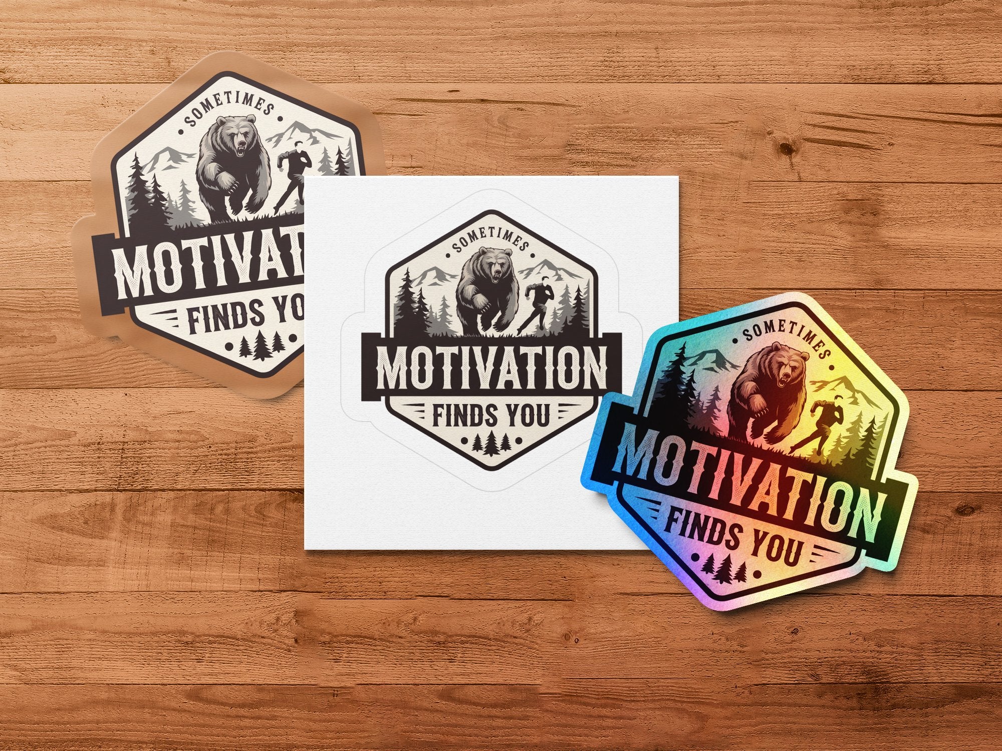 Bear climbing mountain with "Motivation Finds You" text on three stickers.