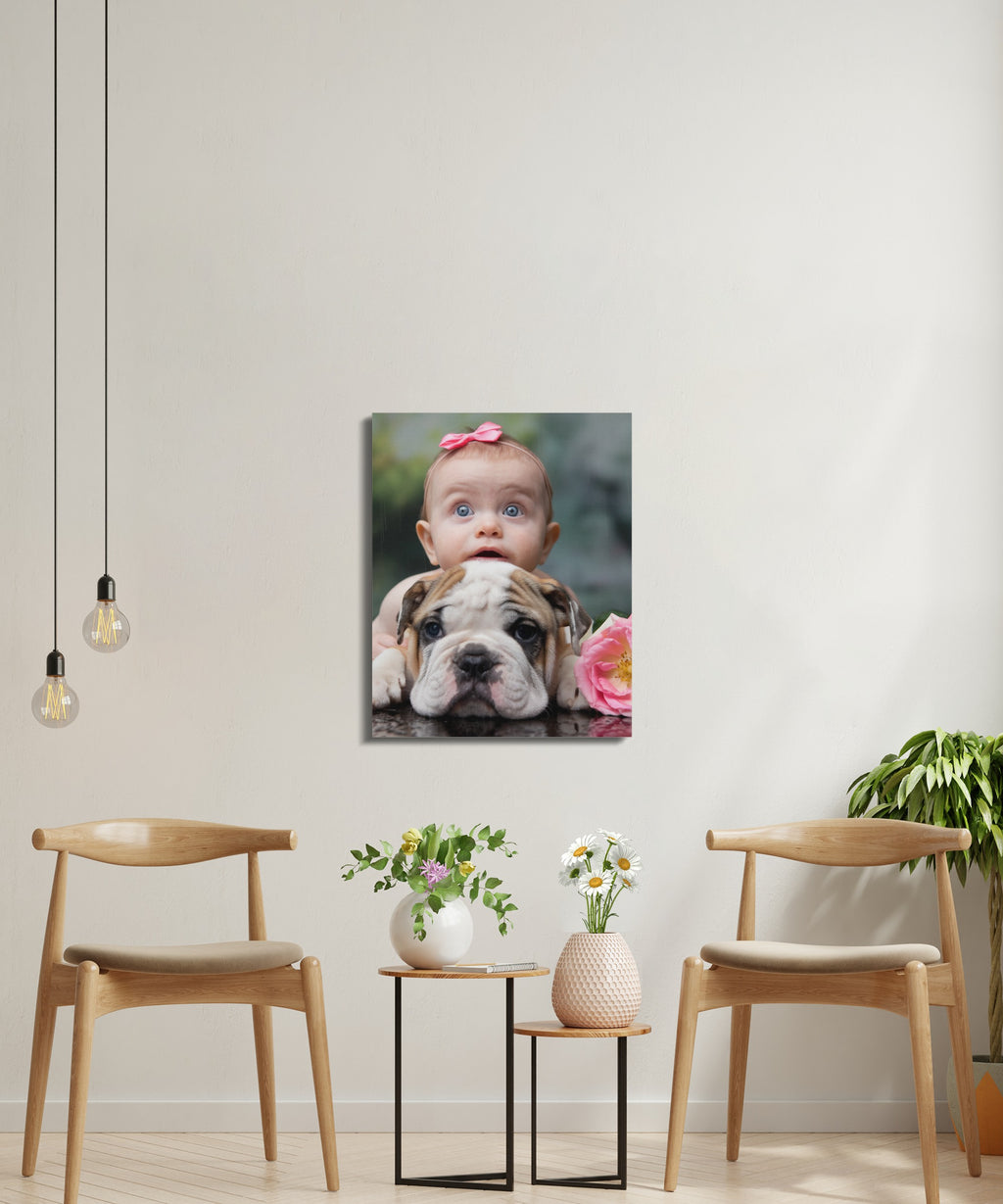 Baby with pink bow peeking over a bulldog in a framed picture.