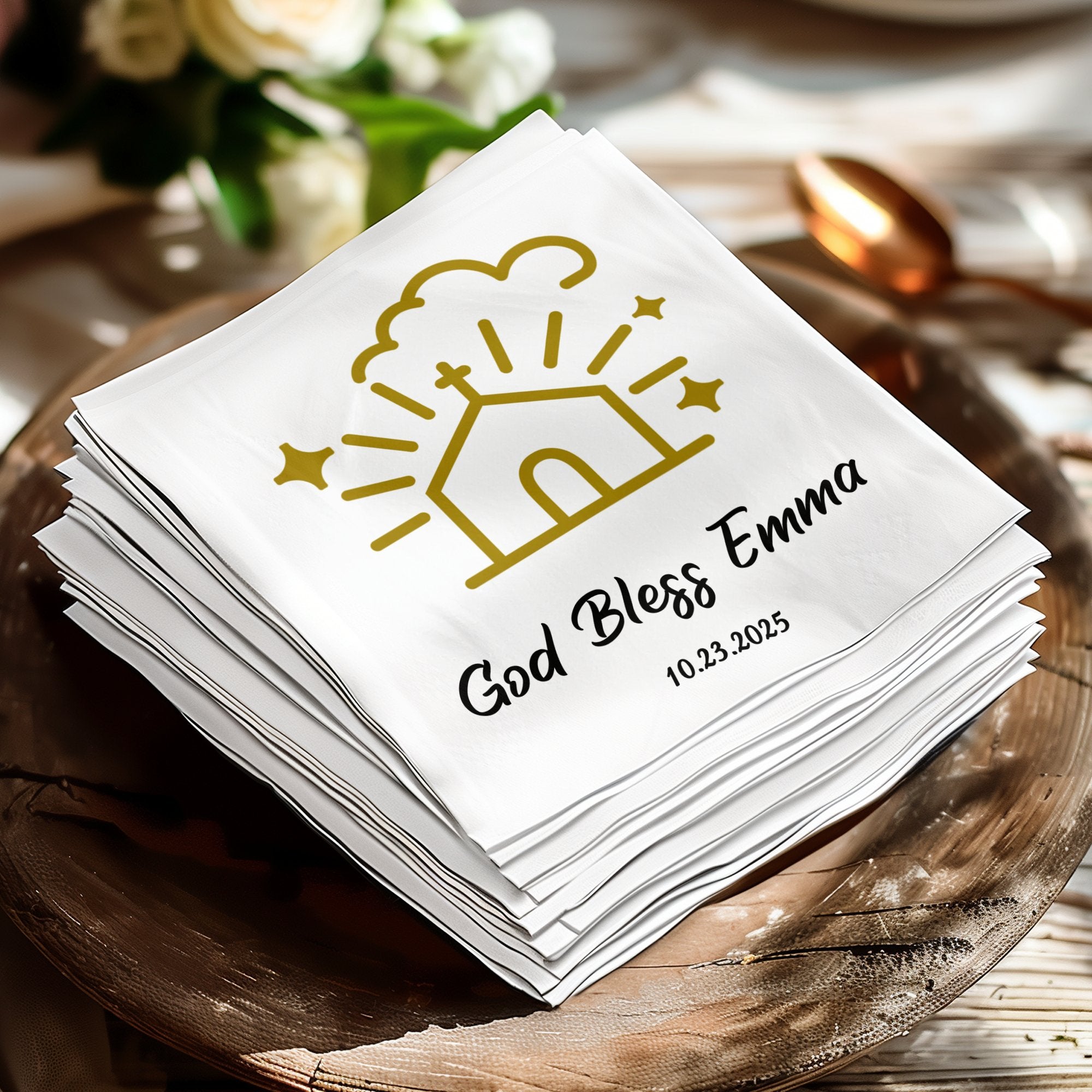 White napkin stack with "God Bless Emma" and date, gold church and star design.