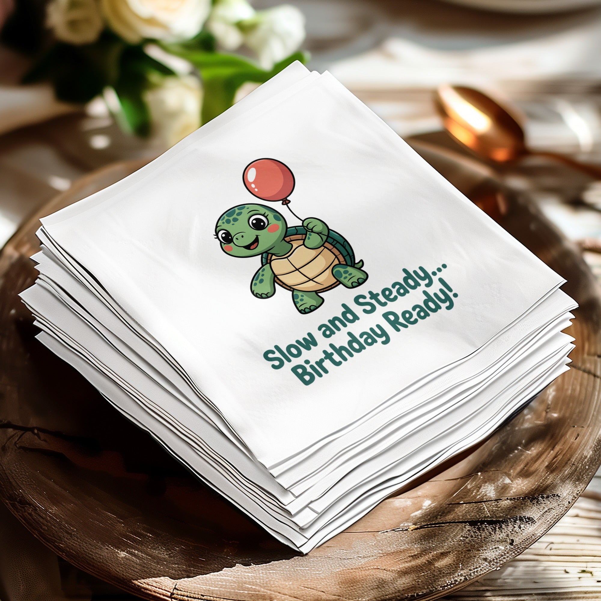 A turtle with a balloon carries a birthday message on a stack of napkins.