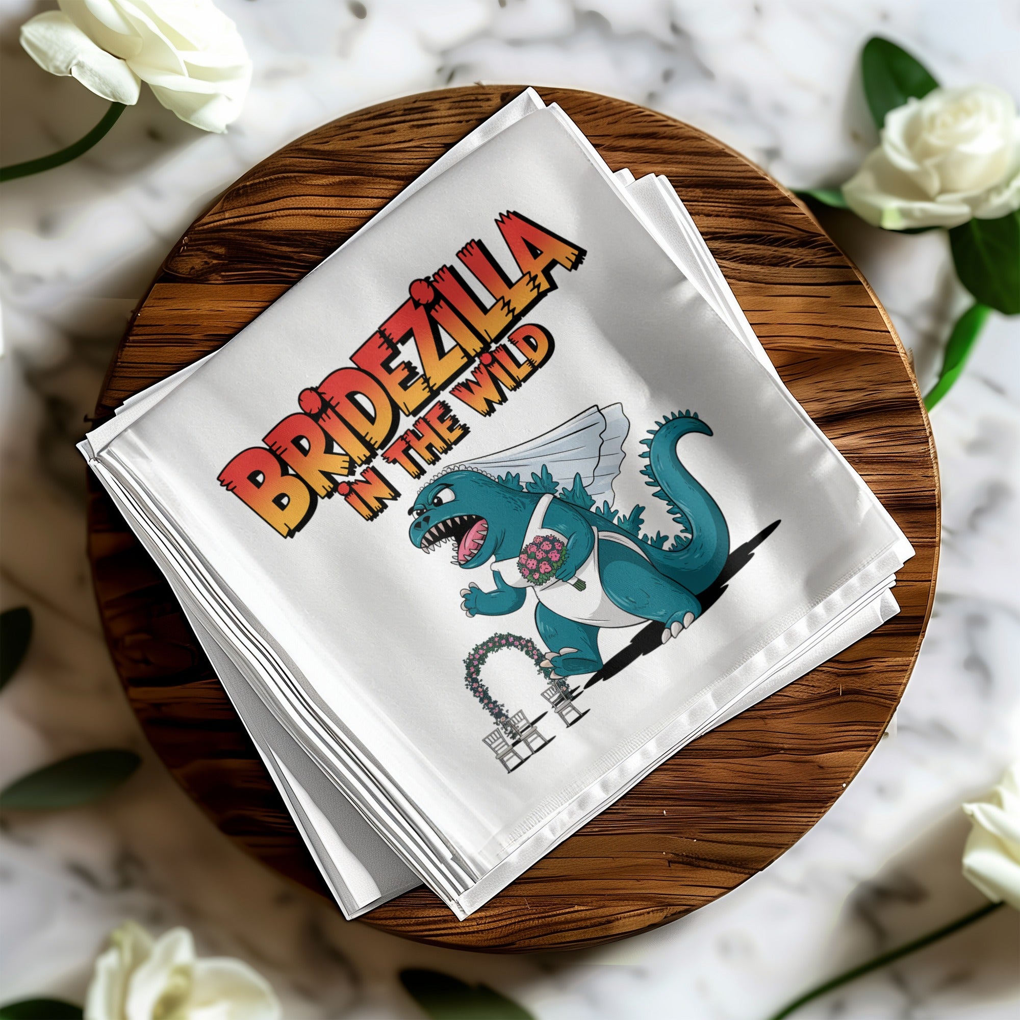 White napkin with "Bridezilla in the Wild" text and a Godzilla-like monster.