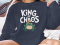 Dark sweatshirt with a frog wearing a crown and text "KING OF CHAOS".