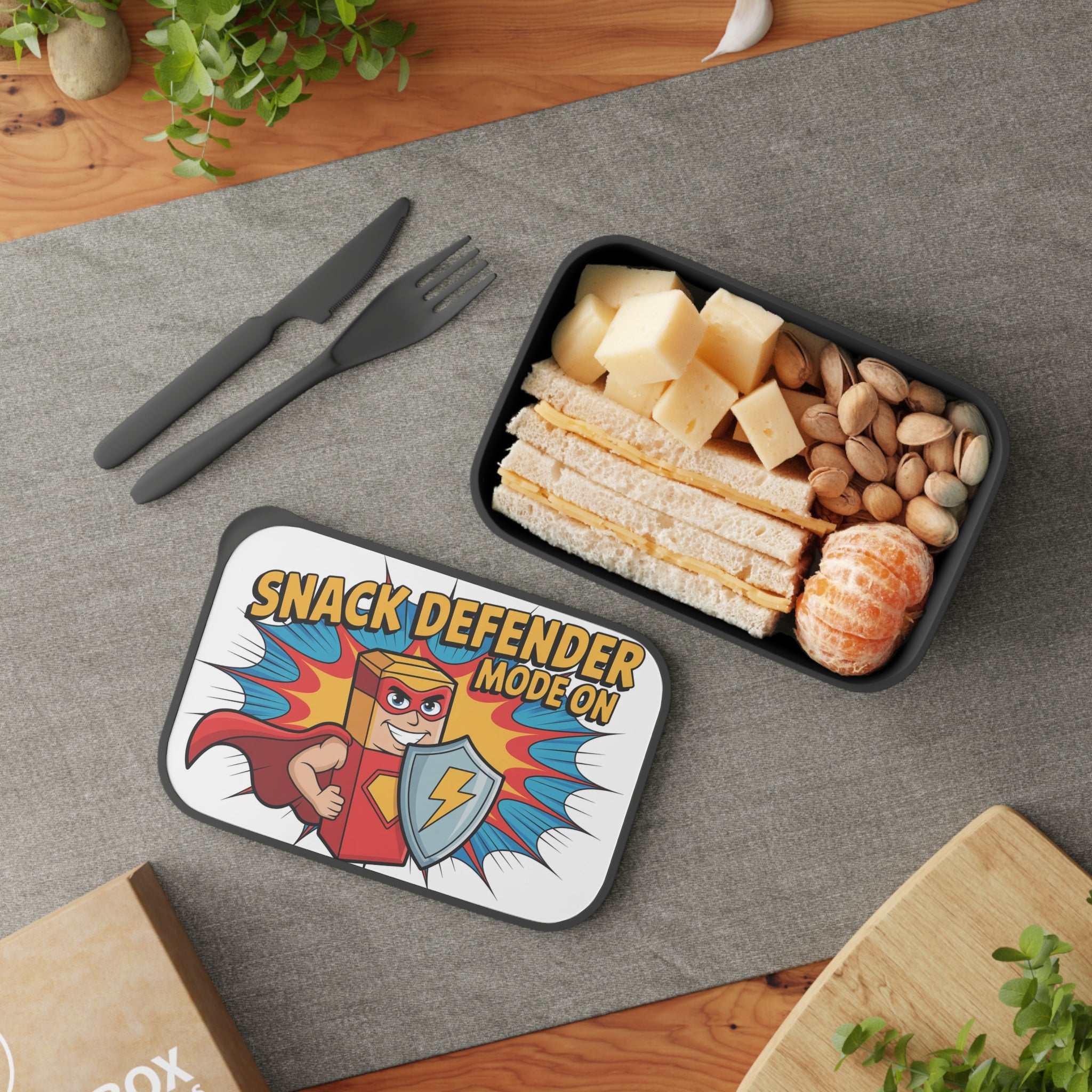 Lunchbox with superhero character, sandwiches, cheese, and nuts.