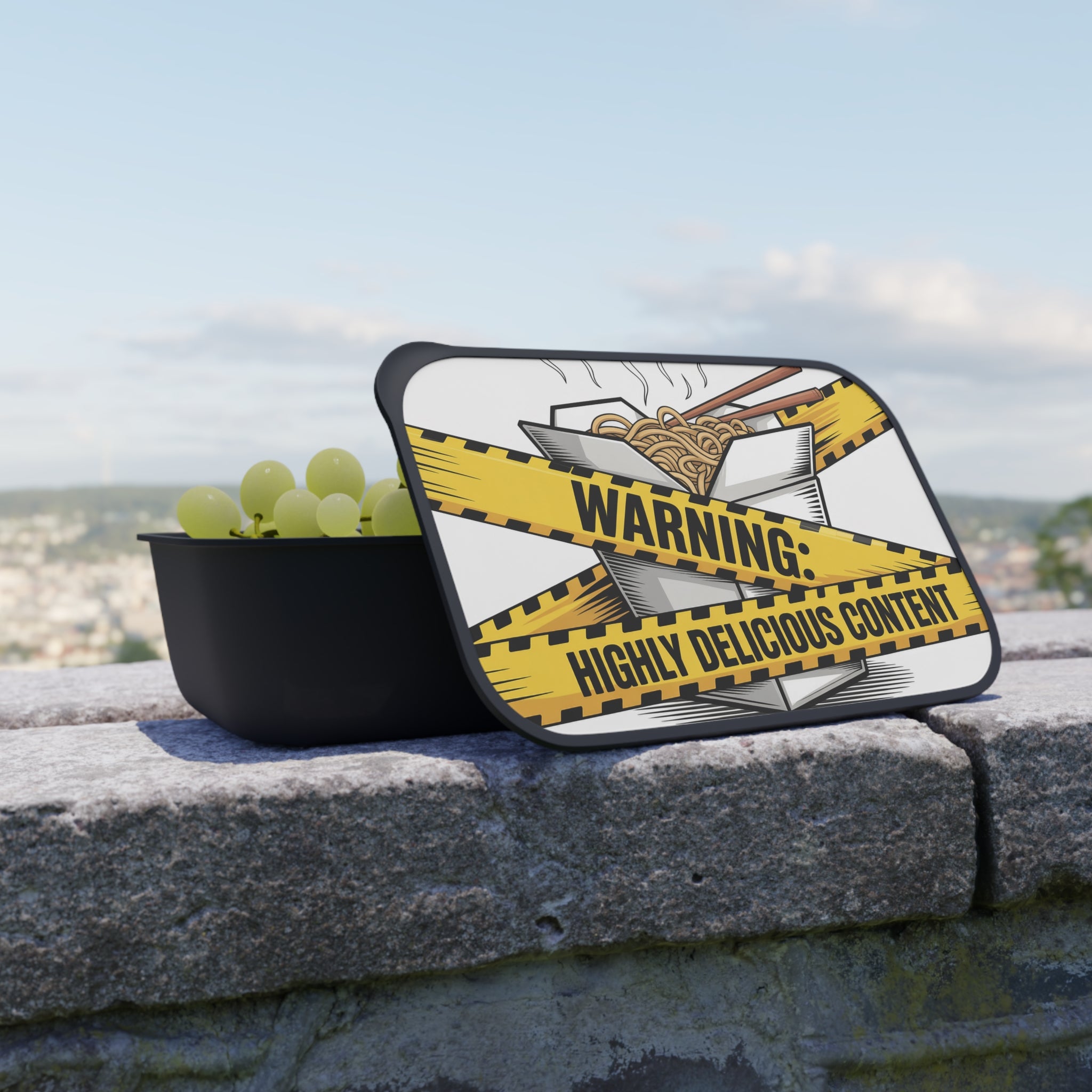 Bowl of grapes with take-out box lid labeled "Warning: Highly Delicious Content".