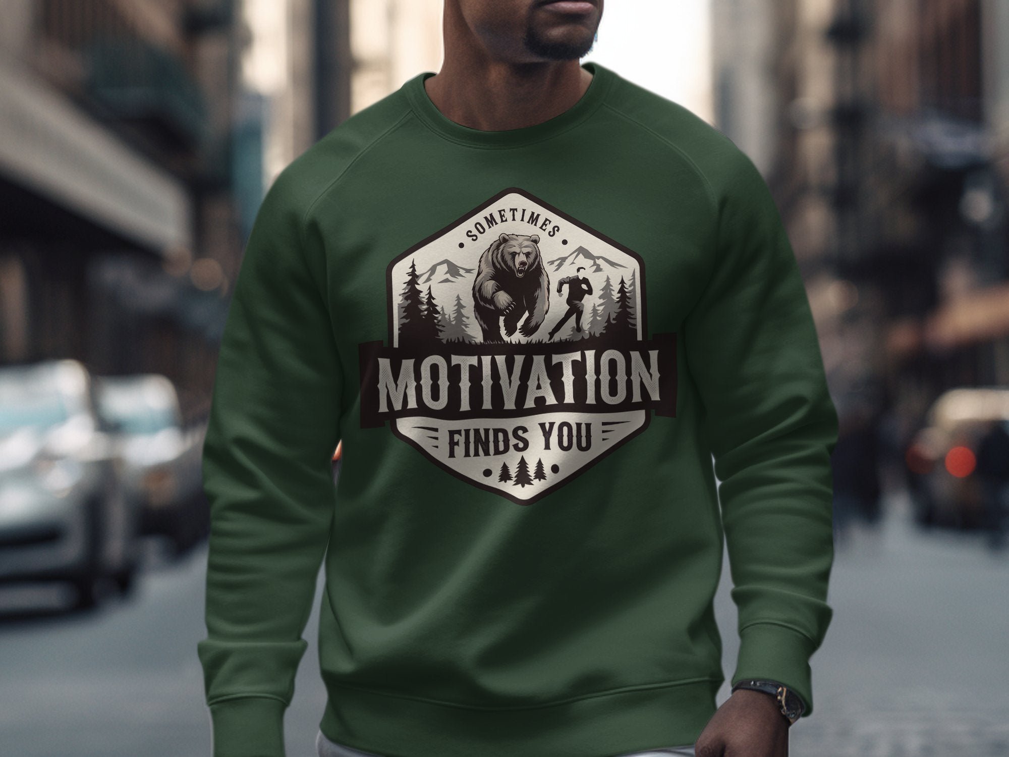 Green sweatshirt with "Motivation Finds You" text and bear graphic.