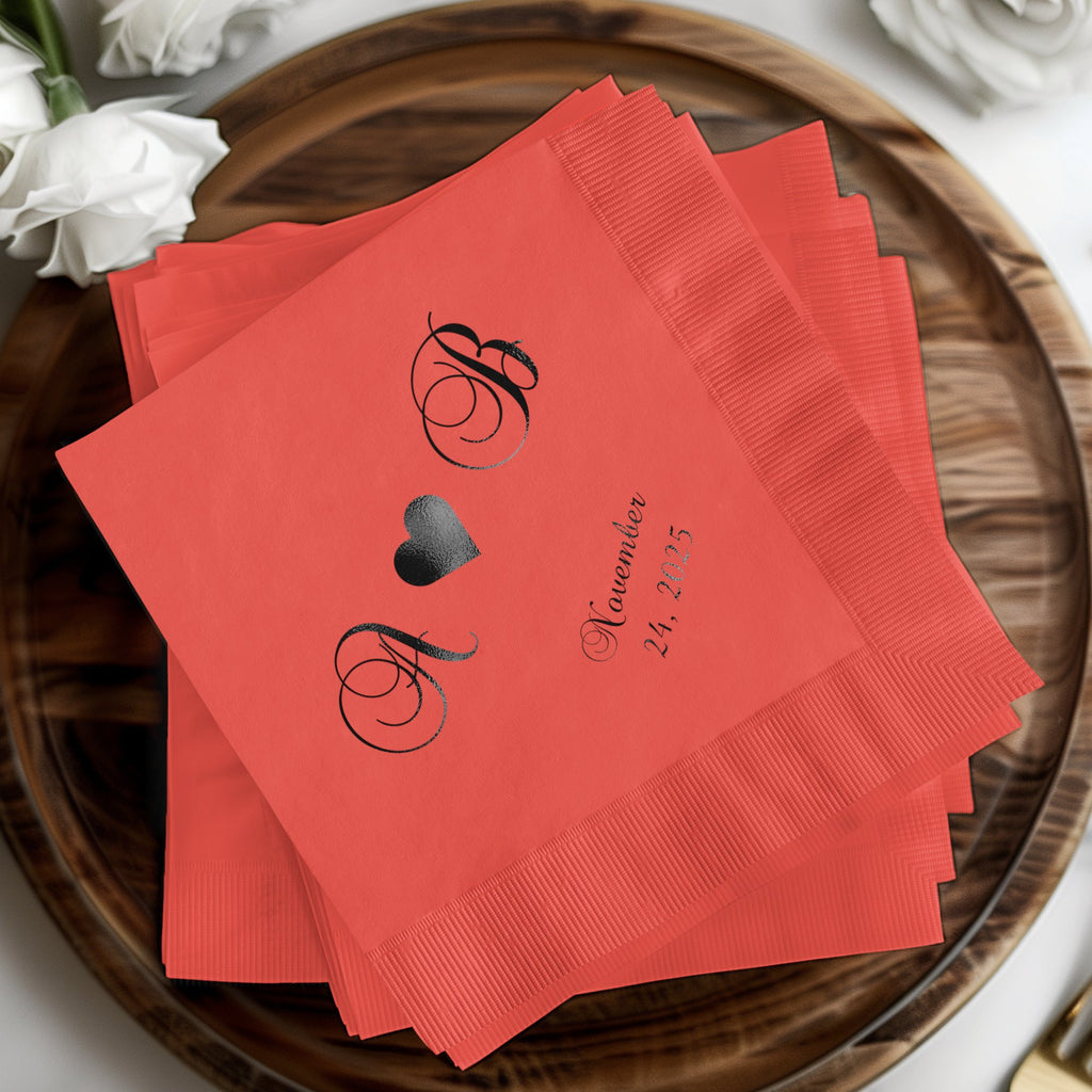 Coral cocktail napkins with black monograms A & B and "November 24, 2025".