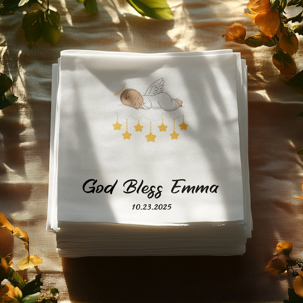 White cocktail napkins with "God Bless Emma" and "10.23.2025" printed in black.
