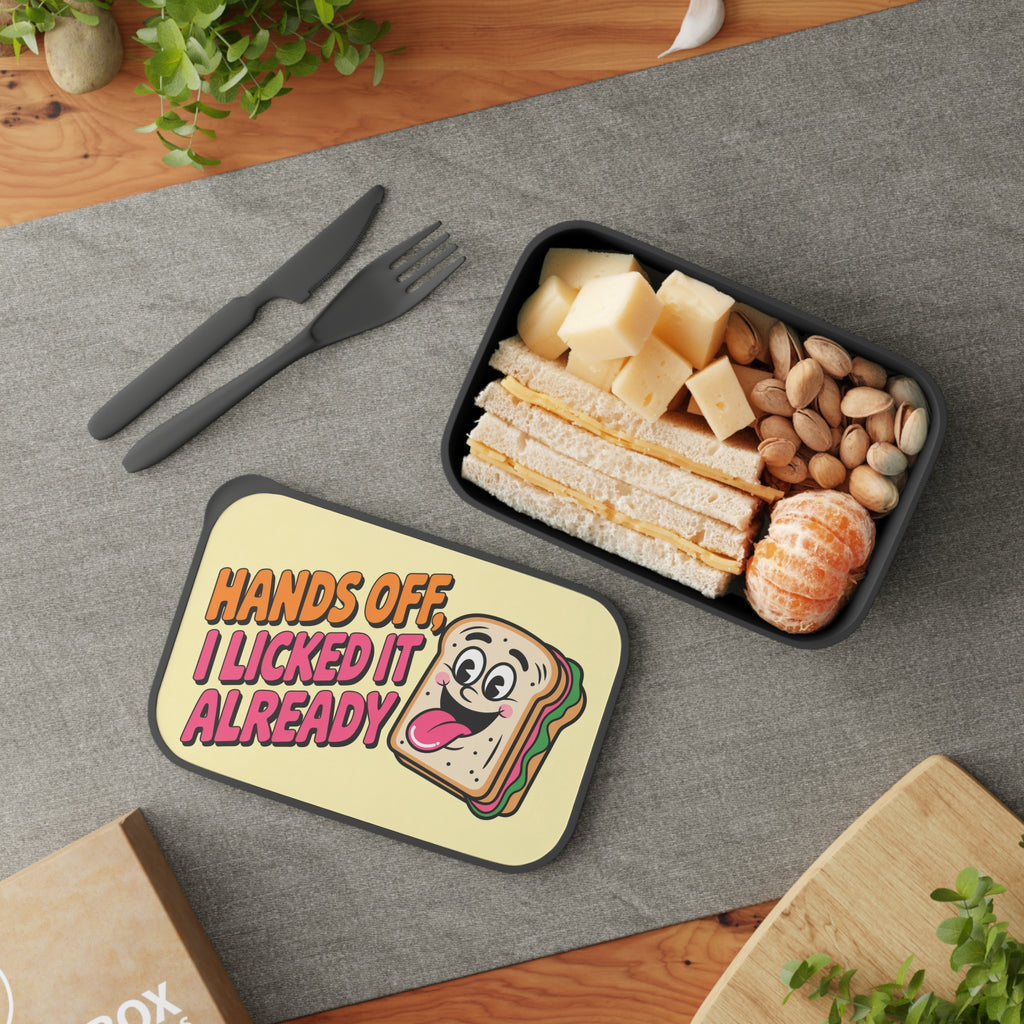 Lunchbox with a smiling sandwich graphic, filled with cheese sandwiches and pistachios.