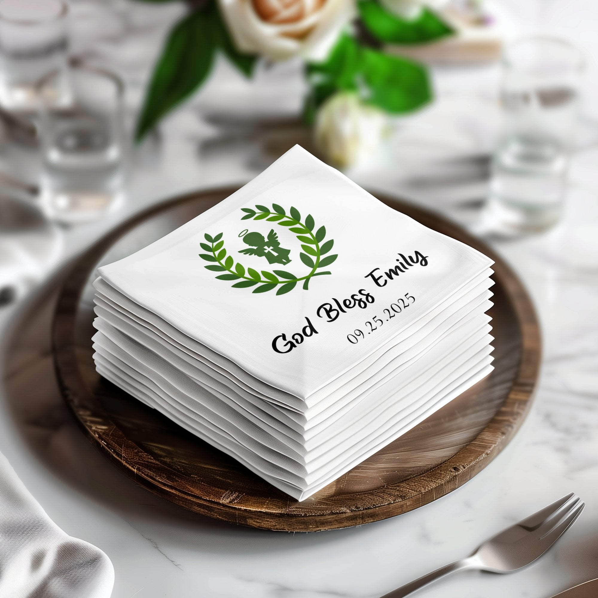Stack of white napkins with "God Bless Emily" and a wreath graphic.