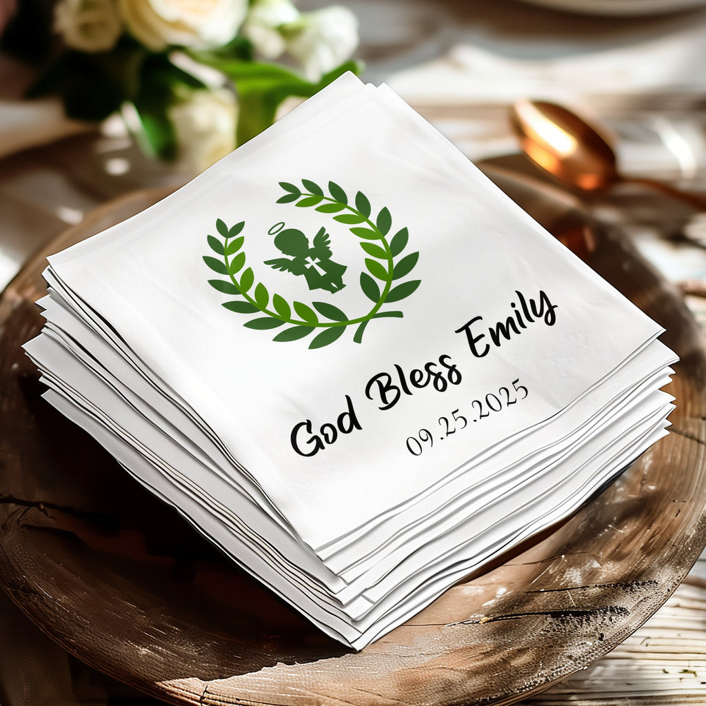 White napkin with "God Bless Emily" and laurel wreath with angel.