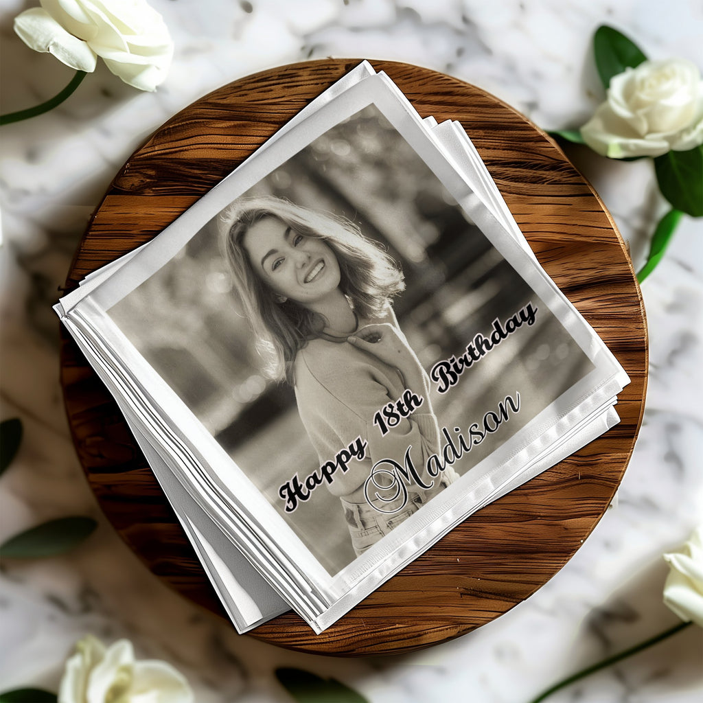 Black and white photo of a smiling young woman on a napkin with "Happy 18th Birthday Madison" text.