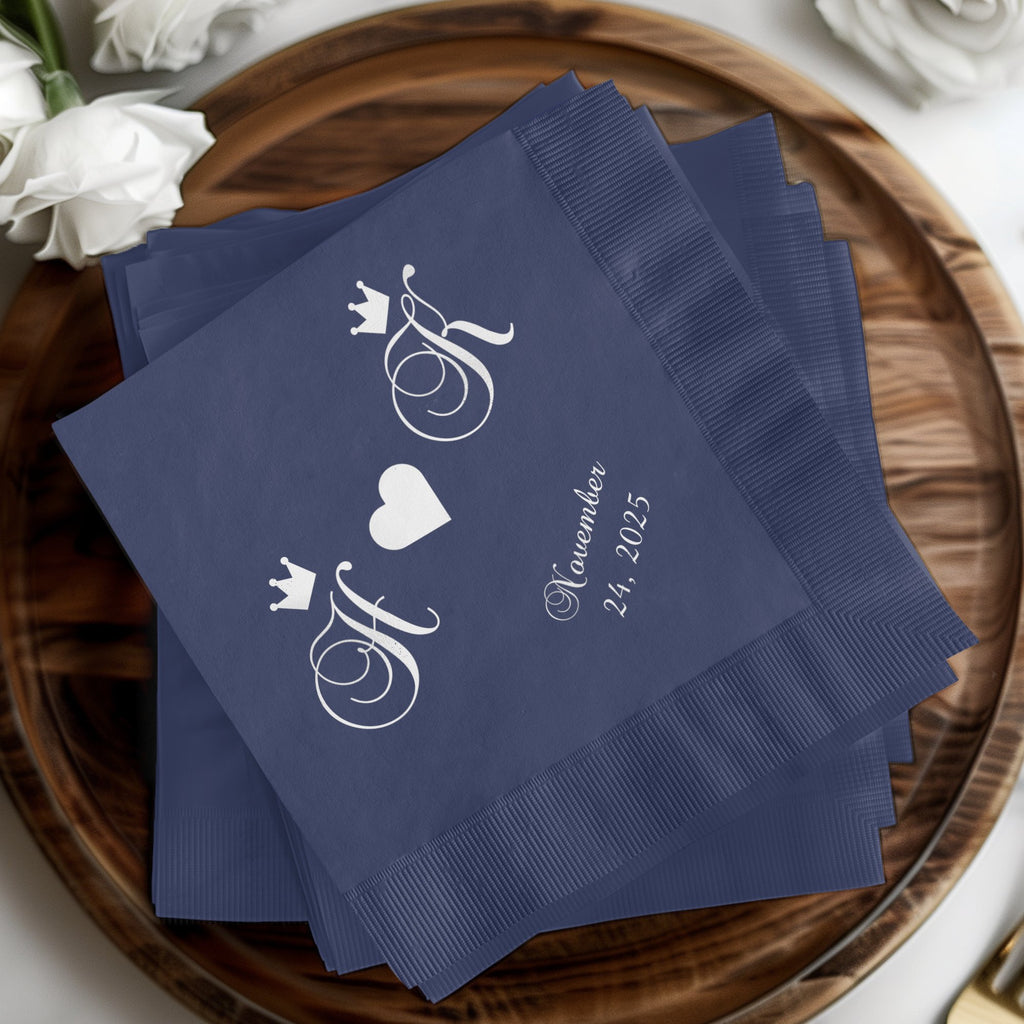 Navy blue napkins with intertwined initials, a heart, and date.