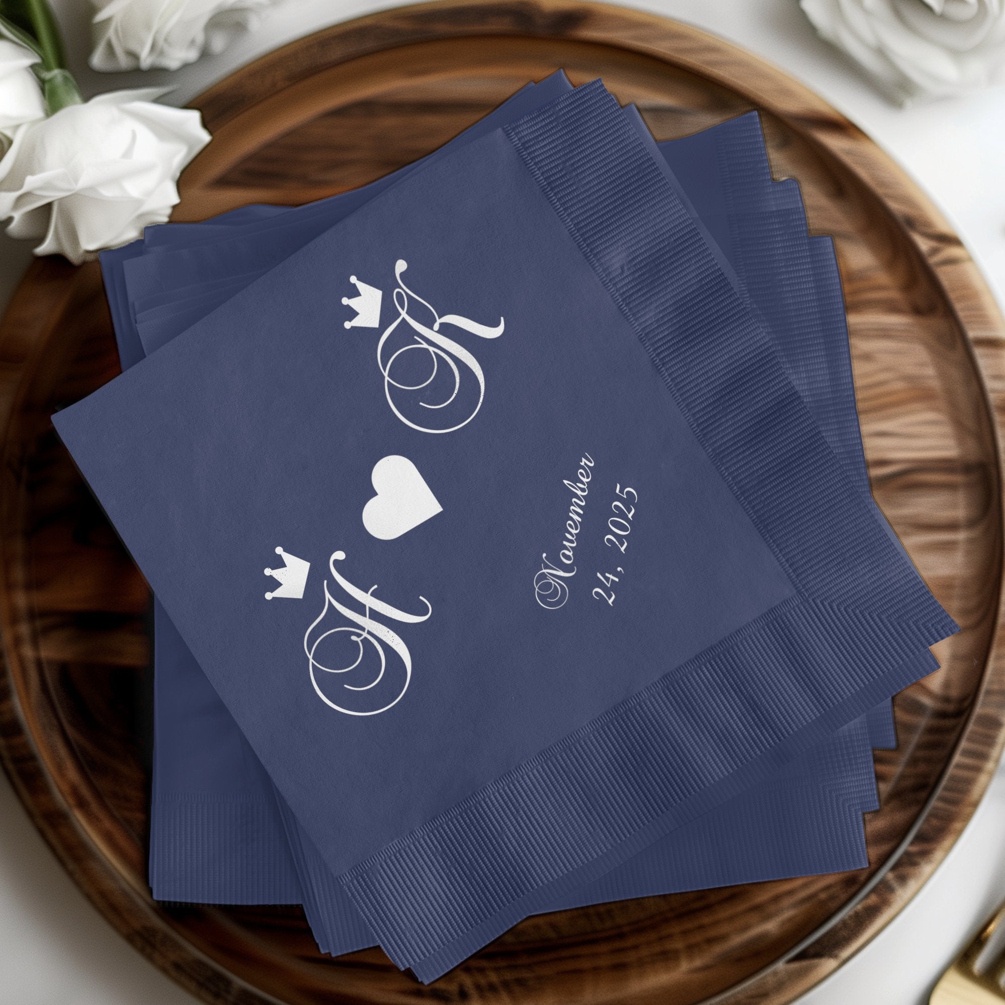 Navy blue napkins with intertwined initials, a heart, and date.