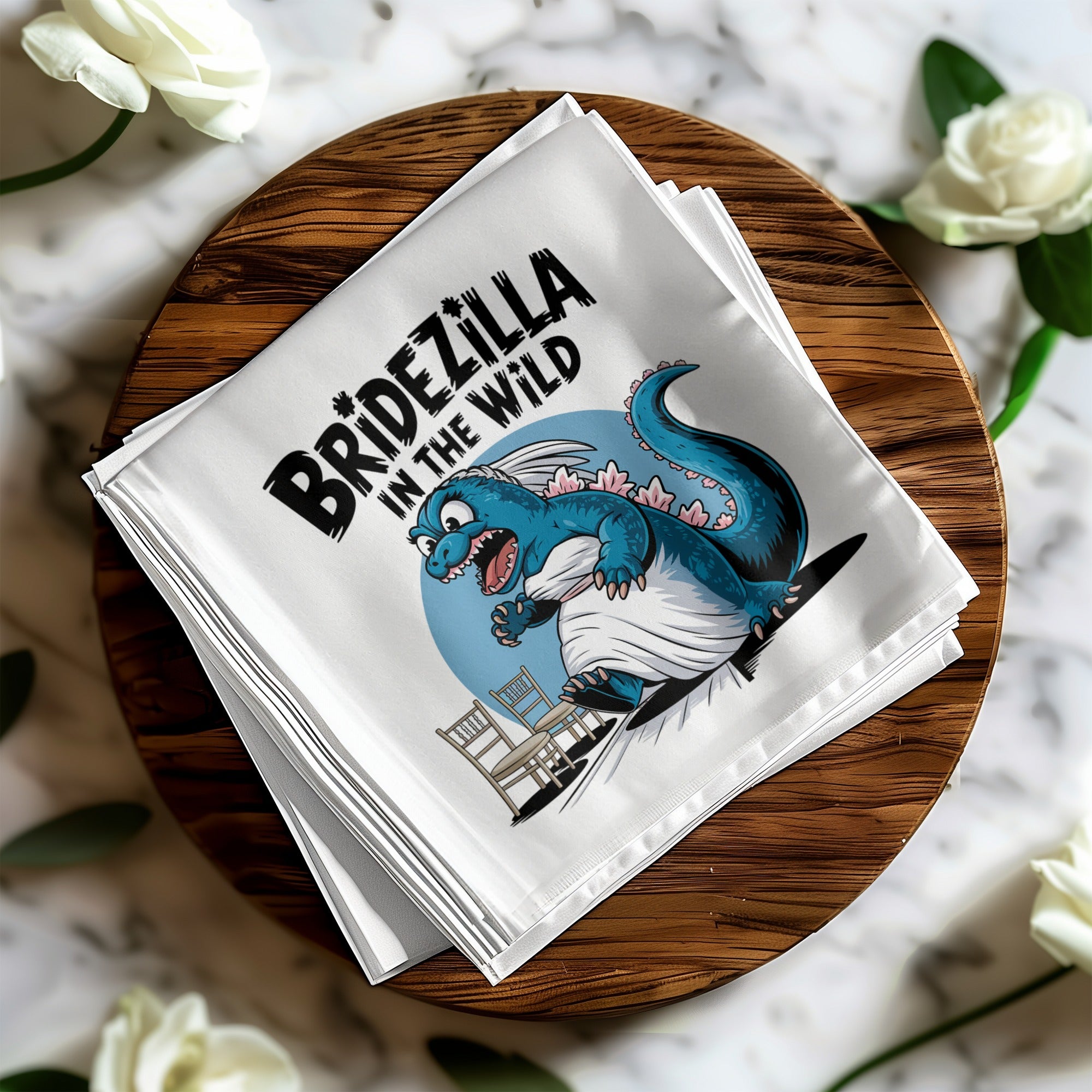 Bridezilla in the Wild text on a blue cartoon dinosaur on a napkin.