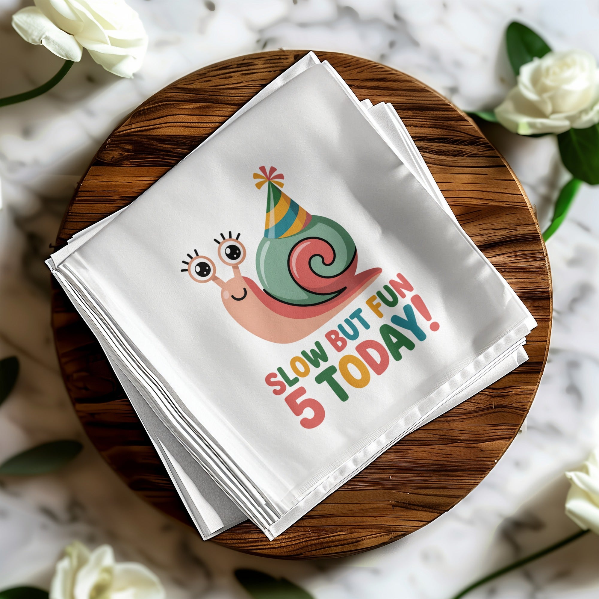 White napkin with a cartoon snail wearing a party hat and "Slow but fun 5 today!"