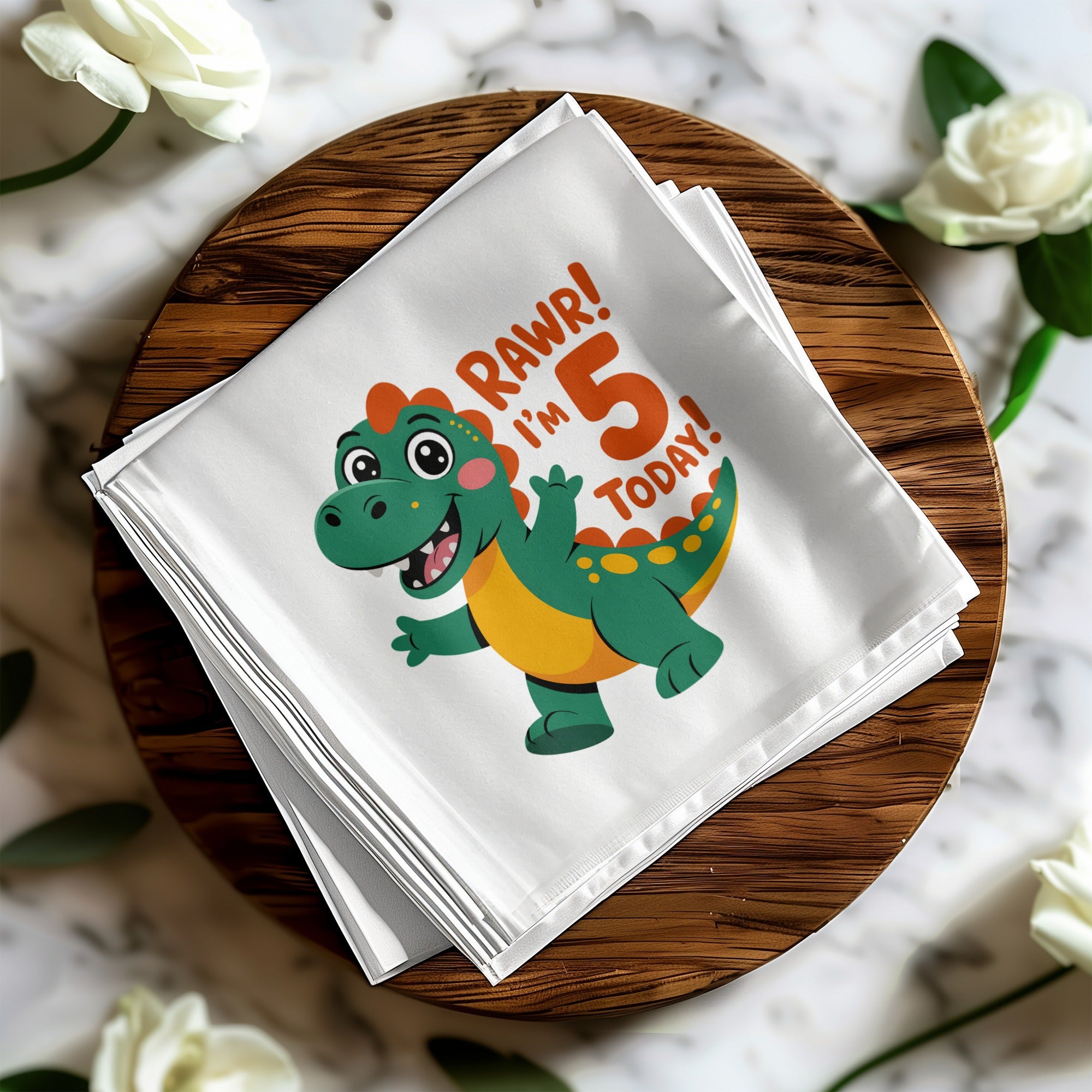 Green dinosaur graphic on white napkin with text "RAWR! I'm 5 TODAY!".