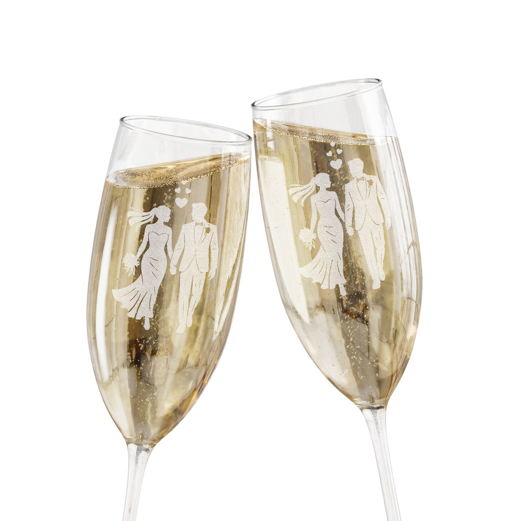 Two champagne flutes with etched silhouettes of couples toasting.