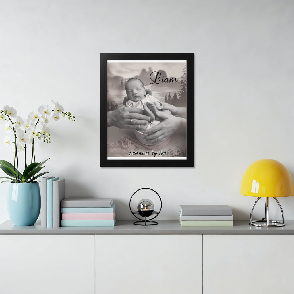 Black and white framed portrait of a sleeping baby held by parents' hands.