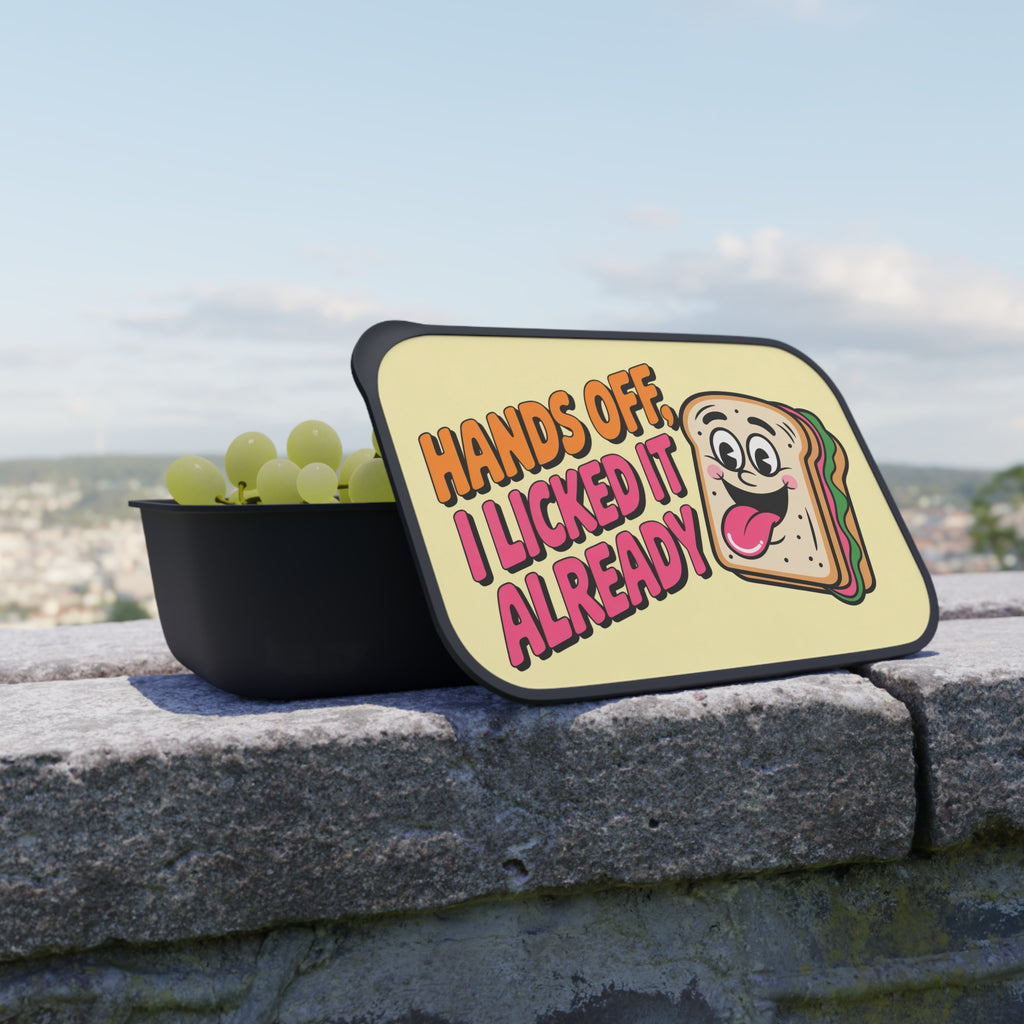 Lunchbox lid with "Hands off, I licked it already" text and cartoon sandwich.