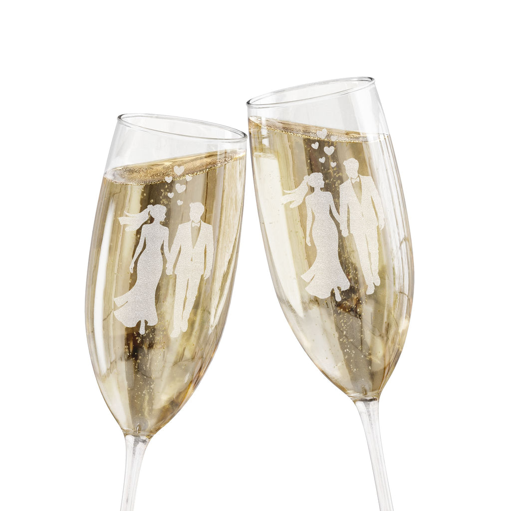 Two champagne flutes clinking, etched with silhouettes of a wedding couple.