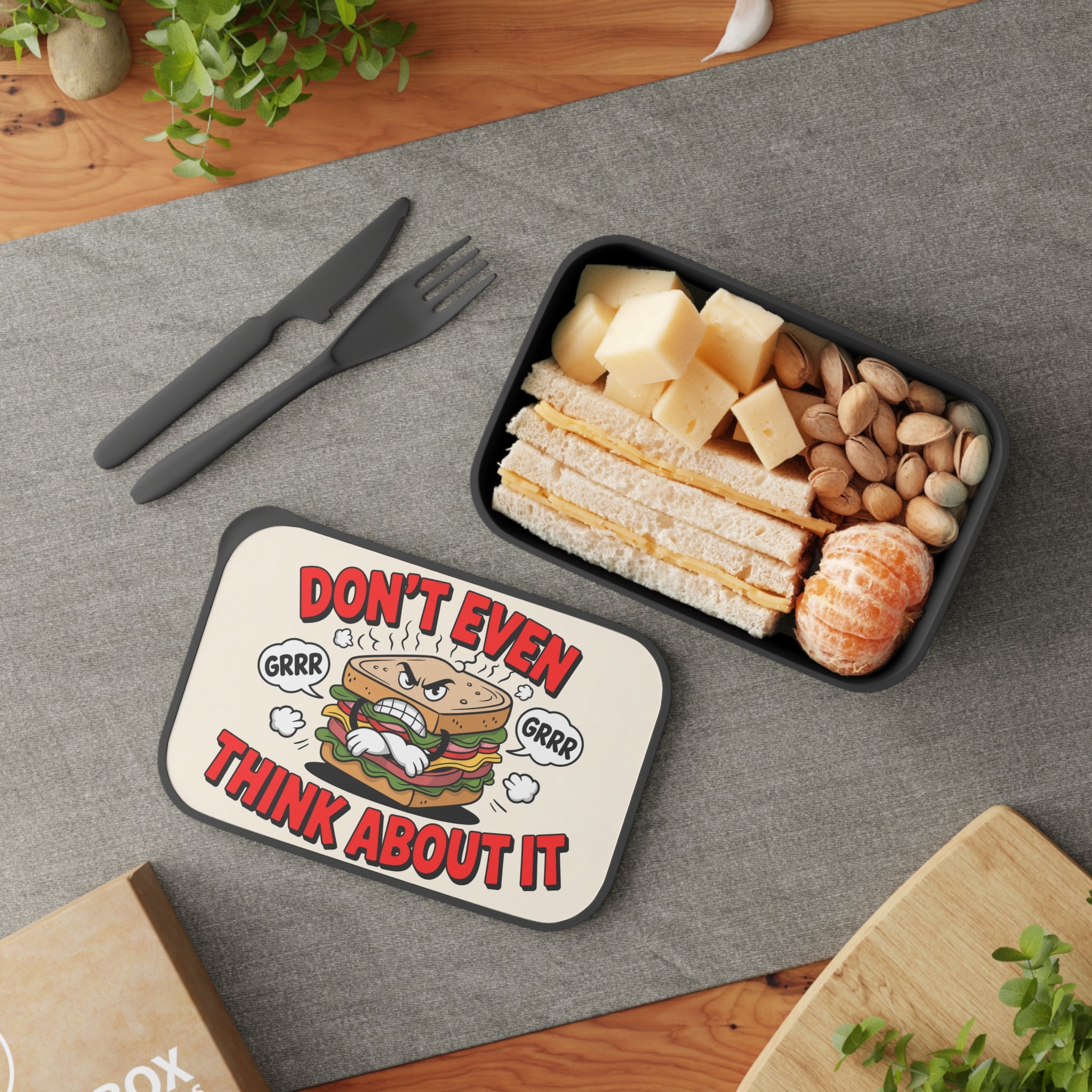 Lunchbox with sandwich and cheese, featuring text "Don't Even Think About It."