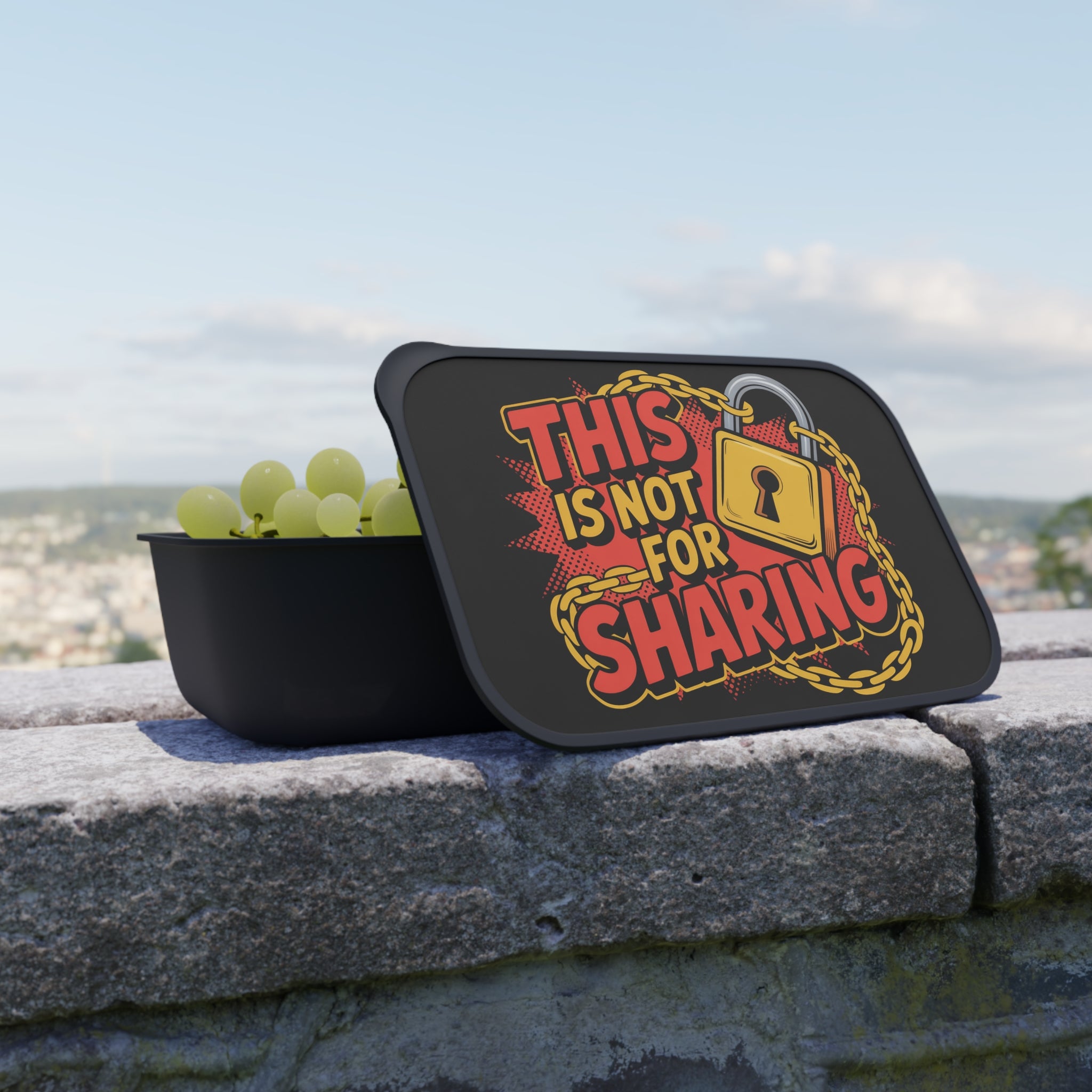 Black container with grapes and lid reading "THIS IS NOT FOR SHARING".