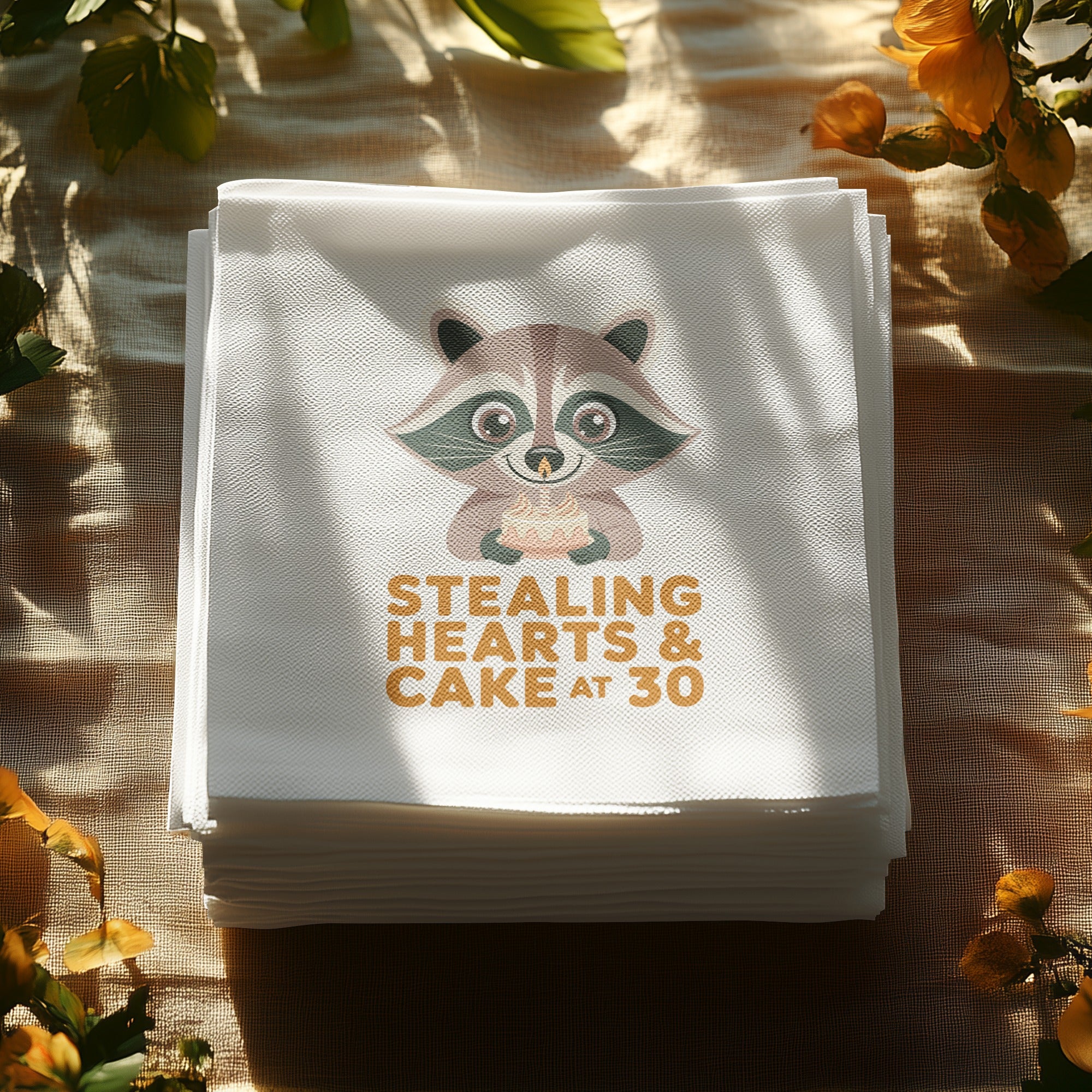 Stack of napkins with a raccoon holding a cake and text "Stealing Hearts & Cake At 30".