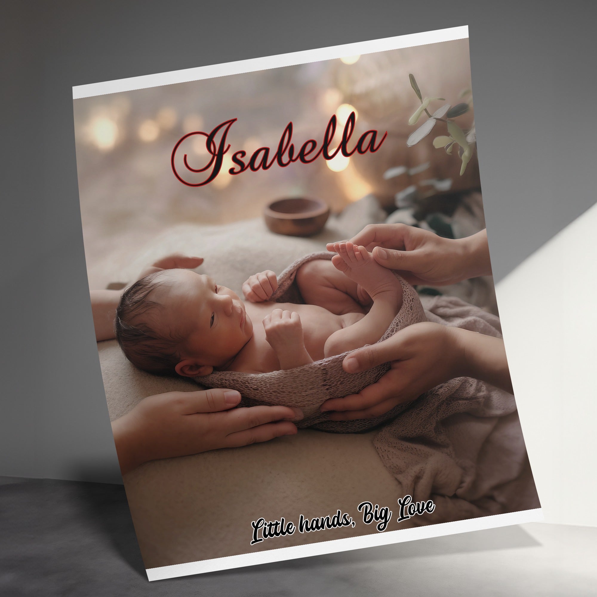 Newborn baby Isabella wrapped in a blanket, held by hands.