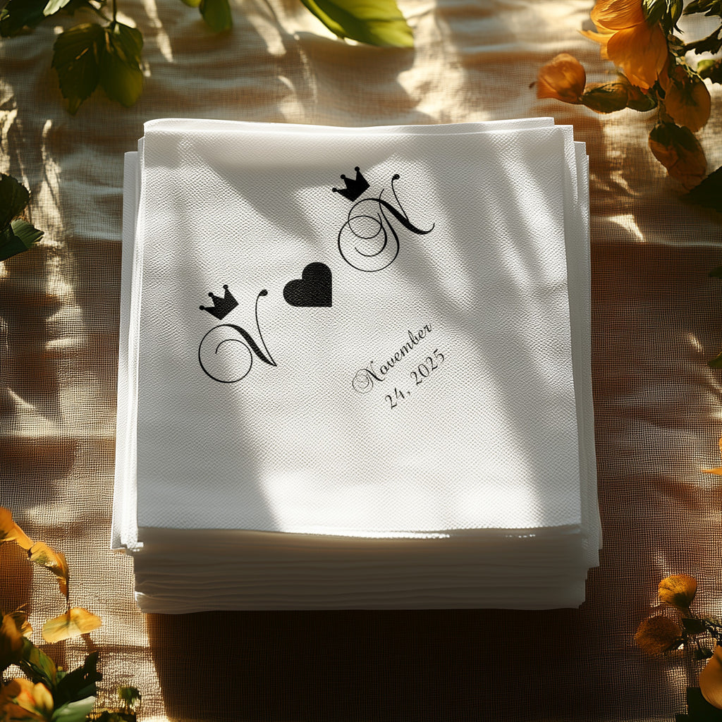 Stack of white cocktail napkins with "N" monograms and a heart.
