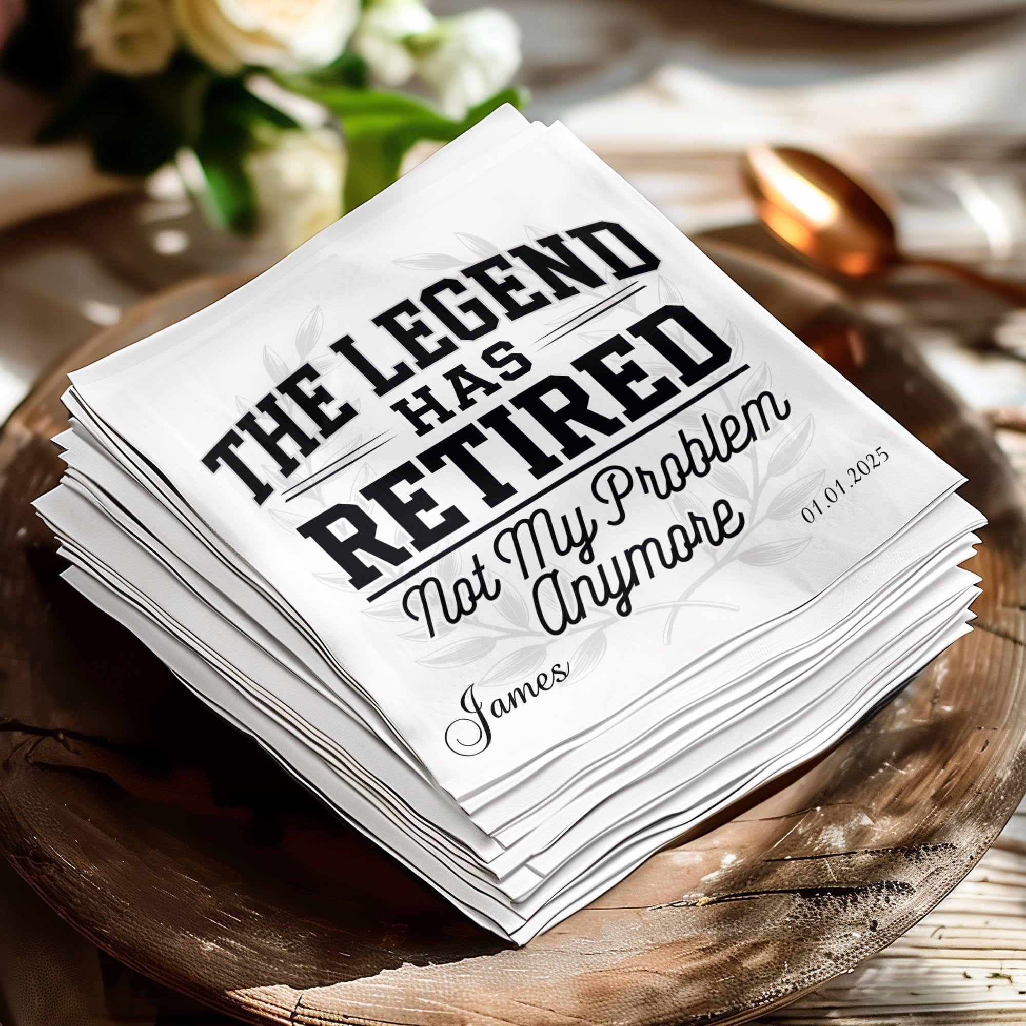 White napkin with "The Legend Has Retired Not My Problem Anymore James" and date.