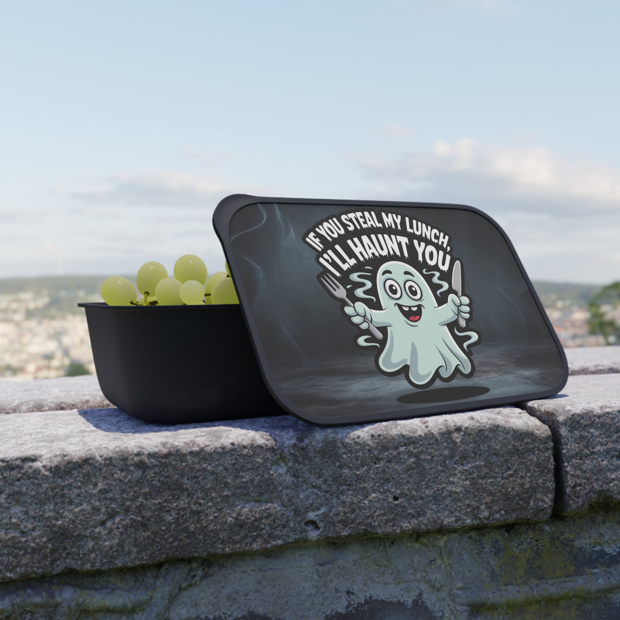 Black lunchbox with a cartoon ghost saying "If you steal my lunch, I'll haunt you."