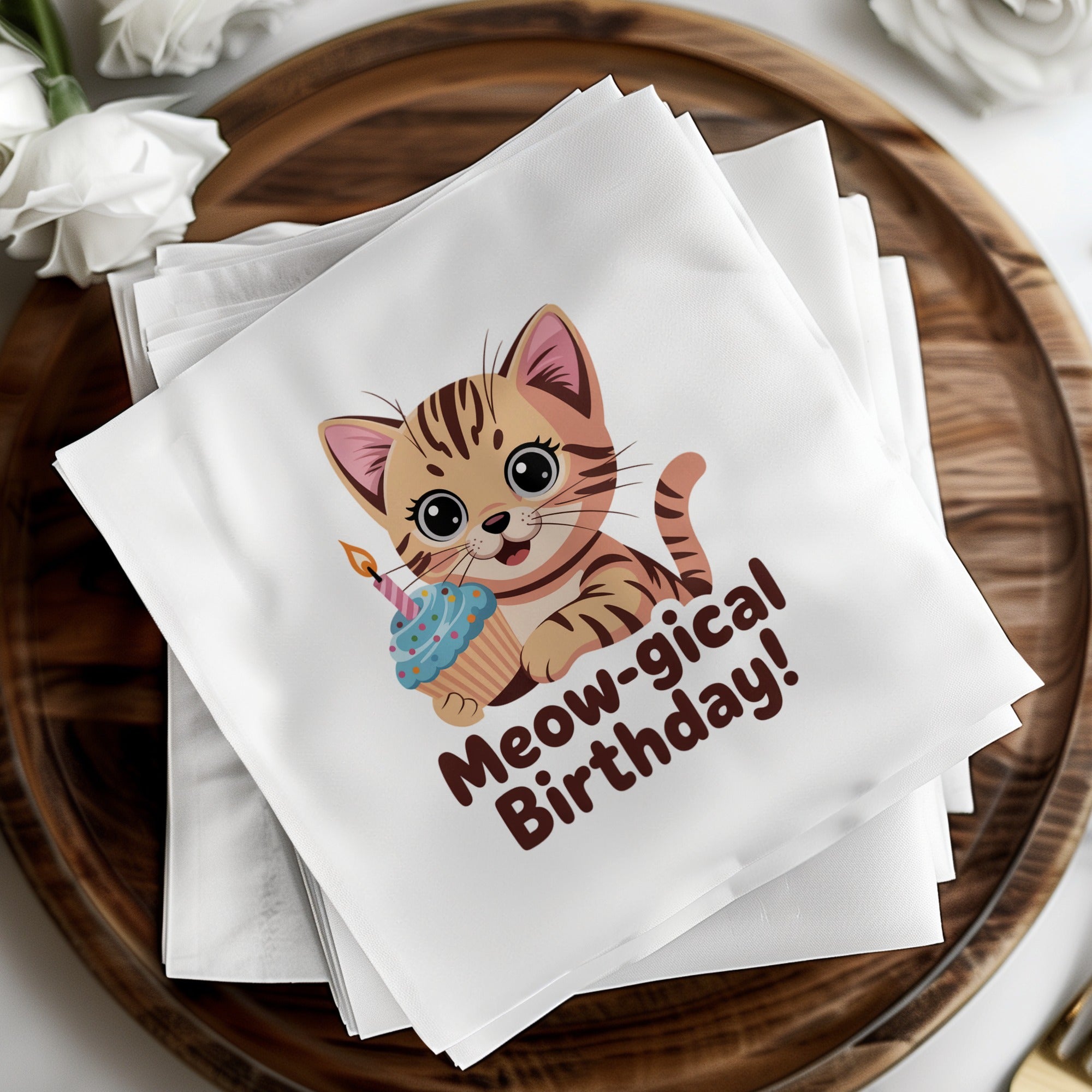 White napkins with a cute kitten holding a birthday cupcake, reading "Meow-gical Birthday".