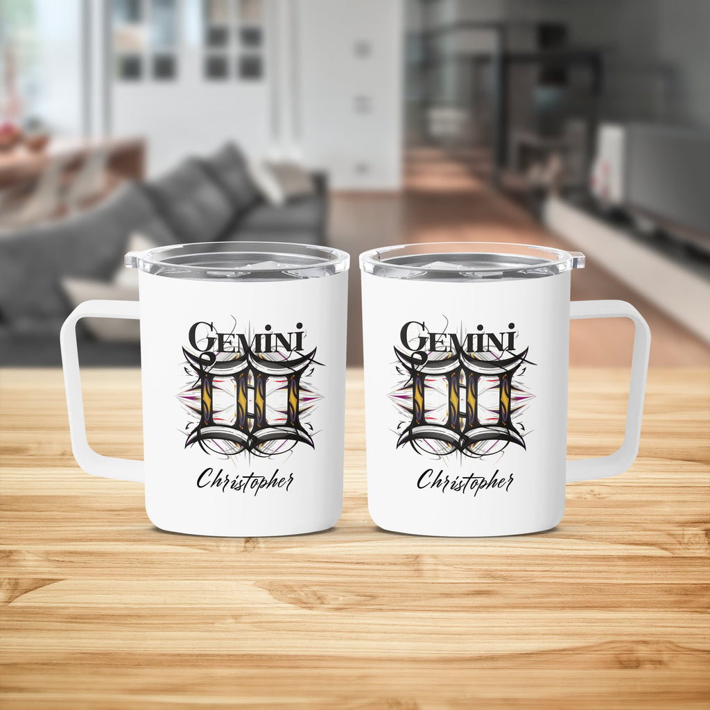 Two white Gemini constellation mugs with personalized names on a wooden surface.
