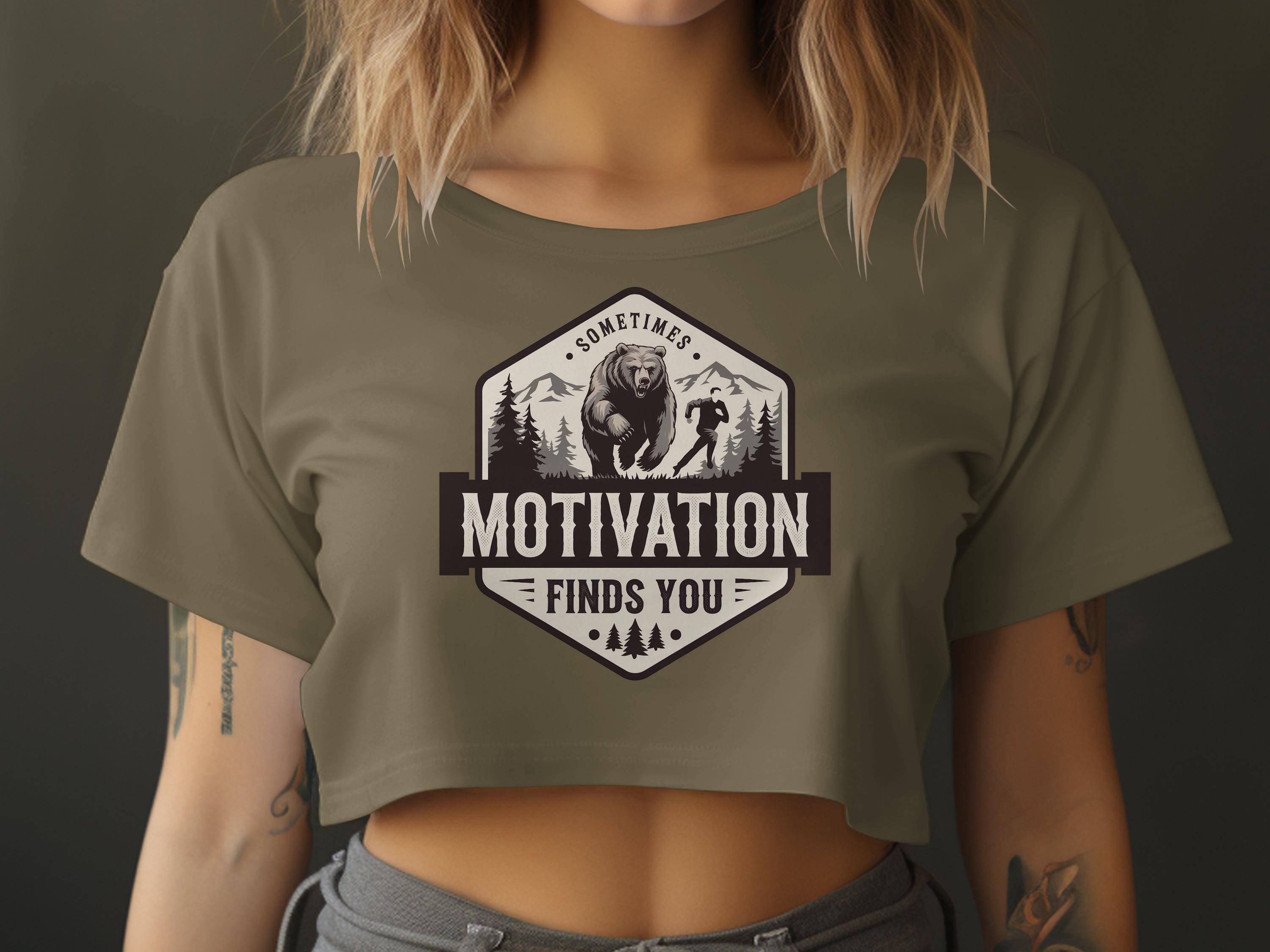 Olive green cropped t-shirt with hexagon graphic featuring bear, runner, and text.