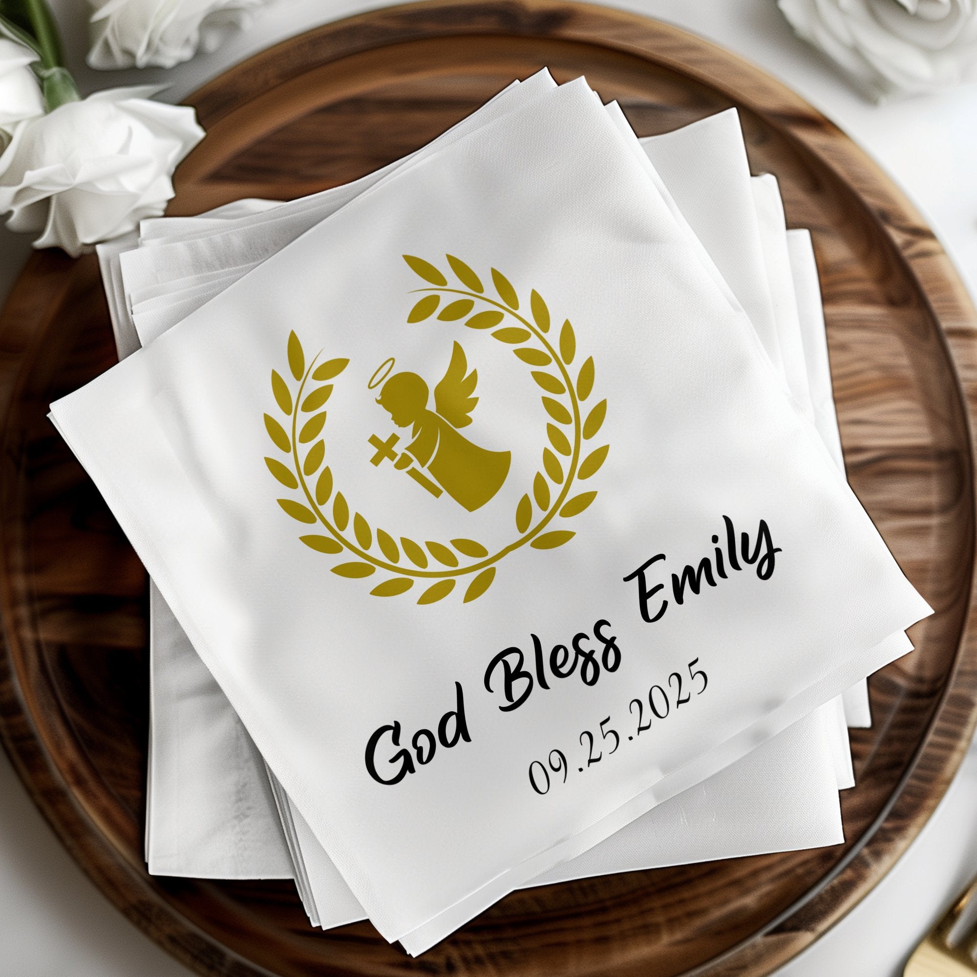 Gold angel with laurel wreath and text "God Bless Emily 09.25.2025" on napkins.